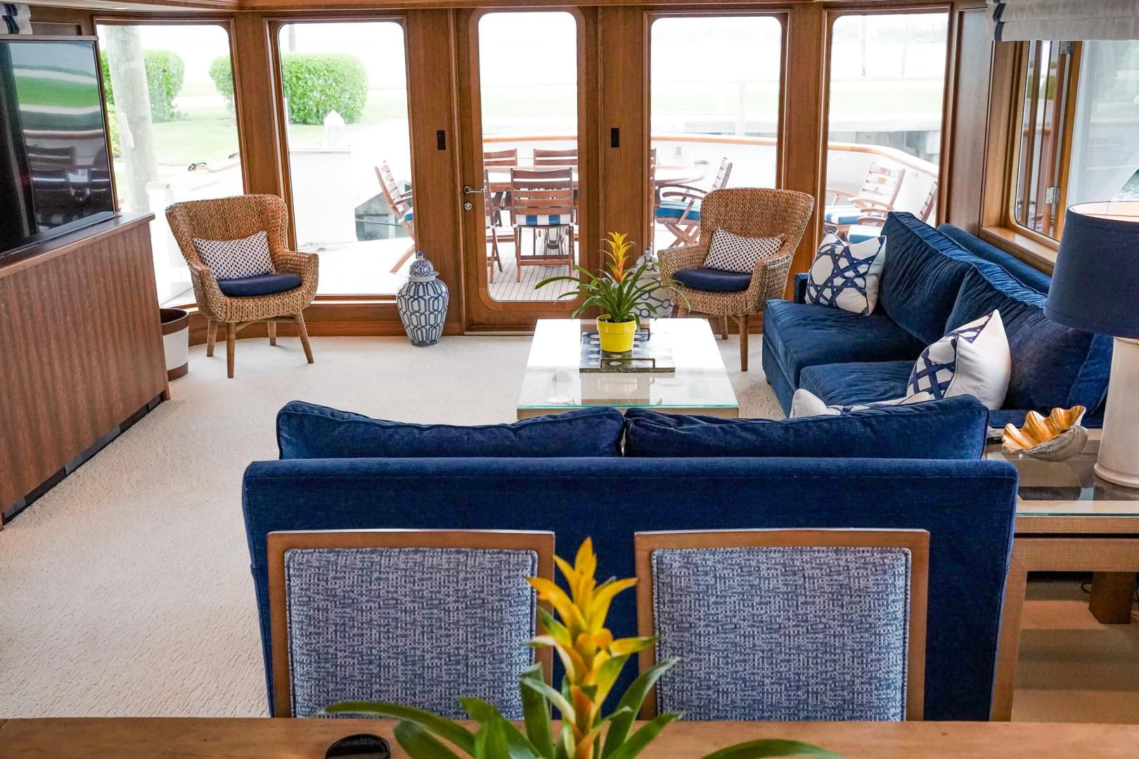 a living room with a blue couch aboard HAU TREE Yacht for Sale