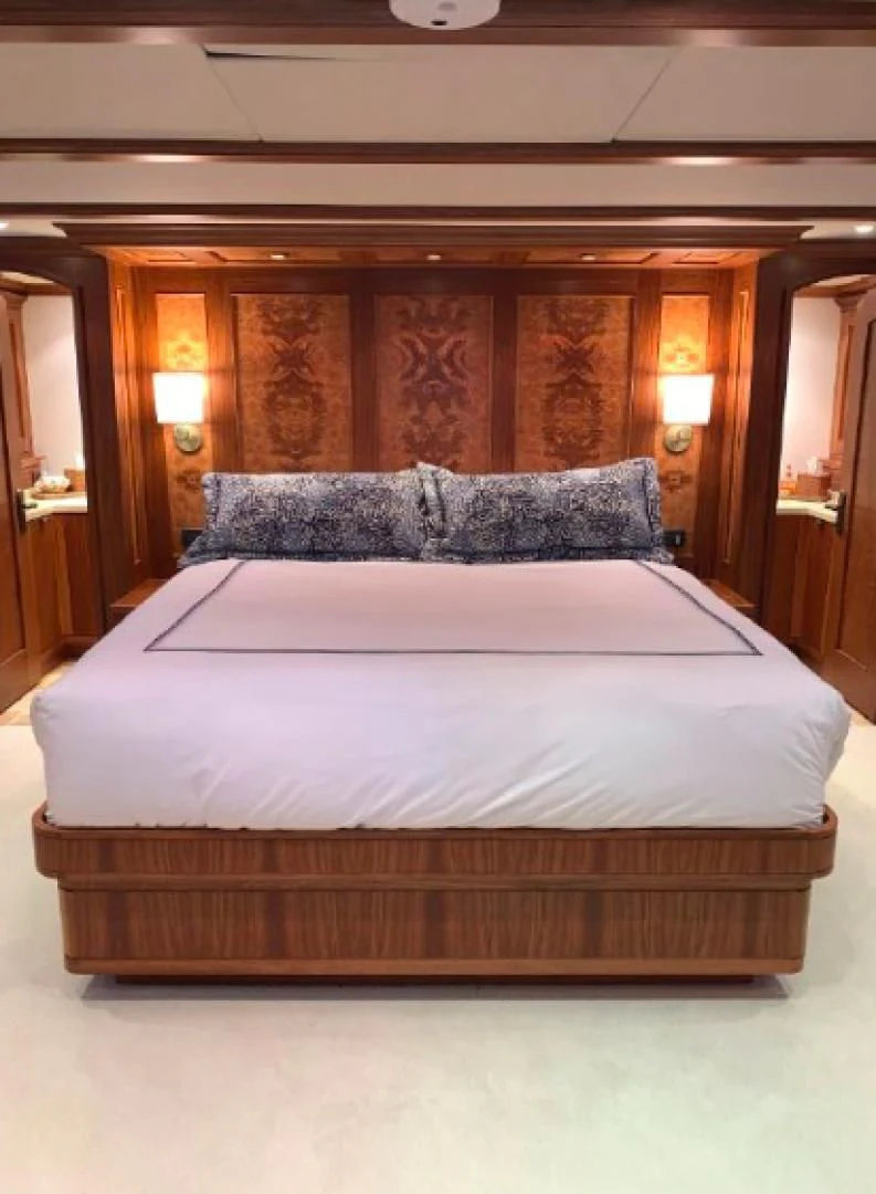 a bed with a white sheet aboard HAU TREE Yacht for Sale