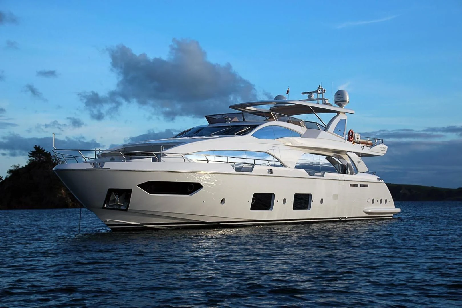 a white yacht on the water aboard LA TACHE Yacht for Sale