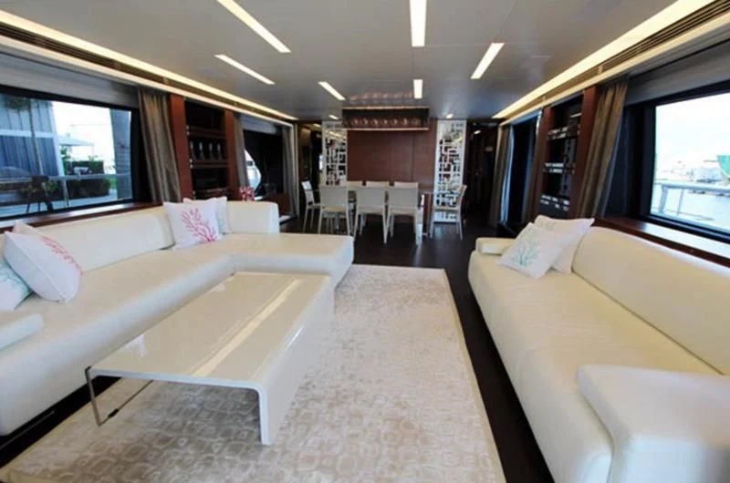 a room with a bed and a couch aboard LA TACHE Yacht for Sale