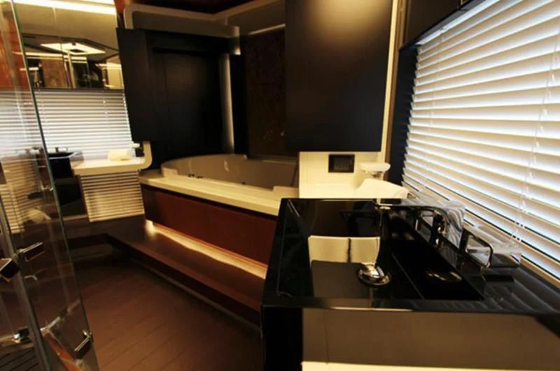 a room with a tub and a sink aboard LA TACHE Yacht for Sale