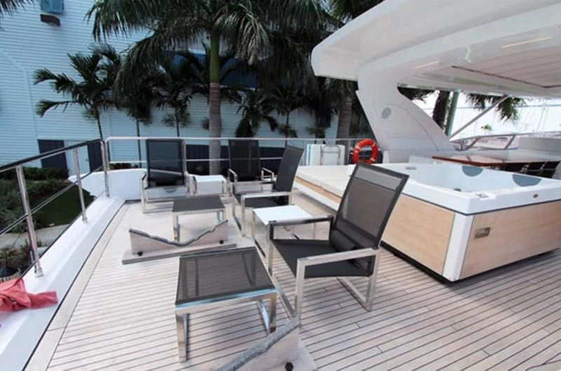 a deck with chairs and tables aboard LA TACHE Yacht for Sale