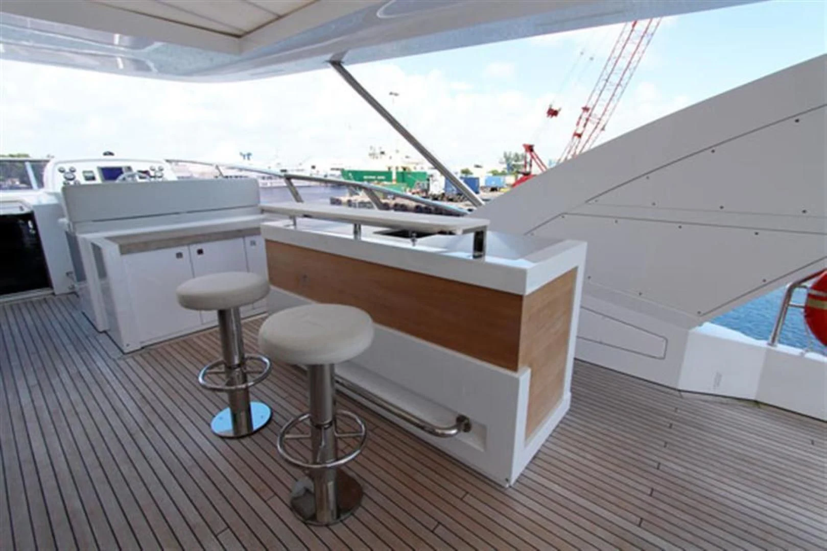 a white boat with stools aboard LA TACHE Yacht for Sale