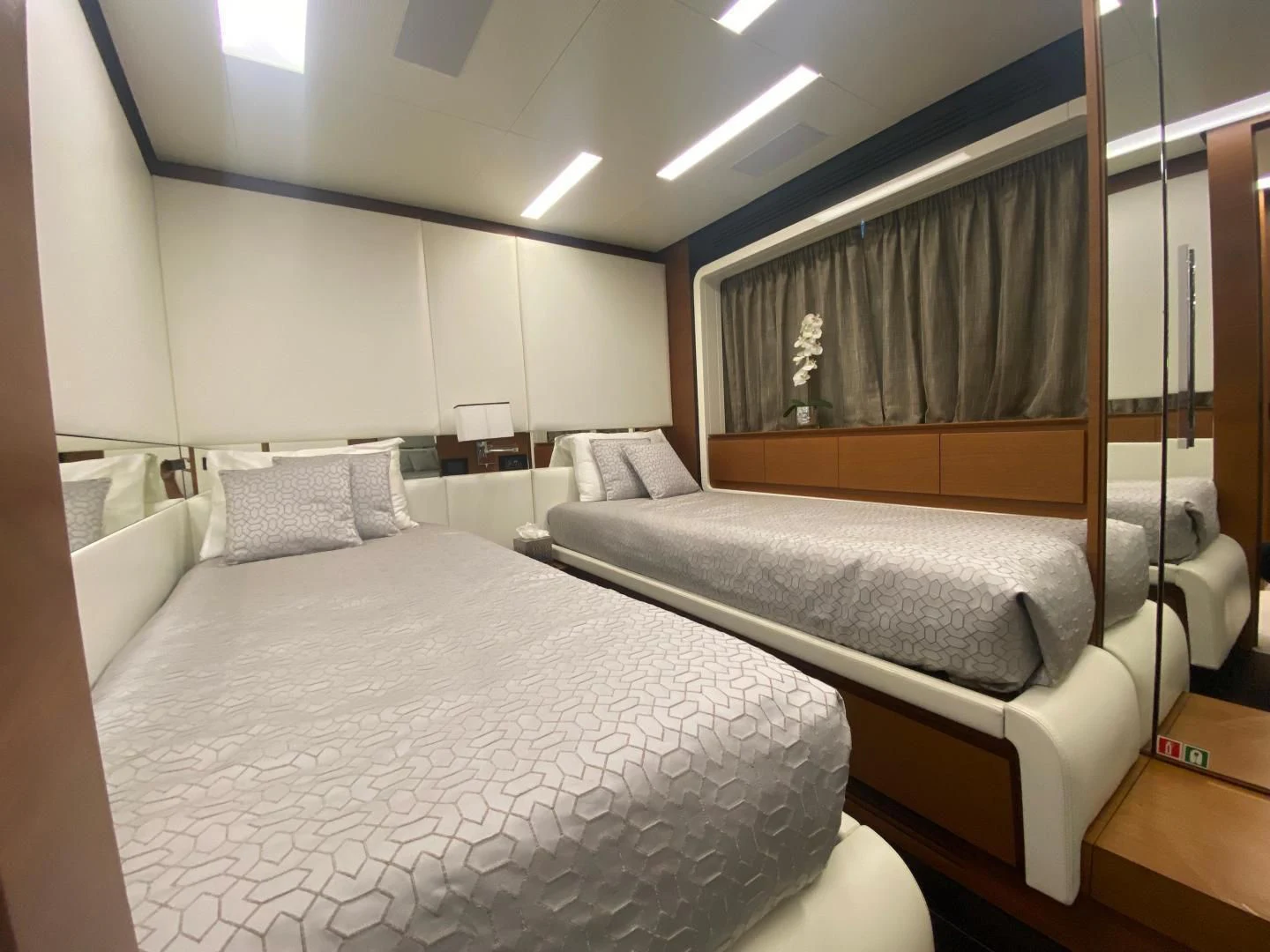 a bedroom with a bed and a desk aboard LA TACHE Yacht for Sale