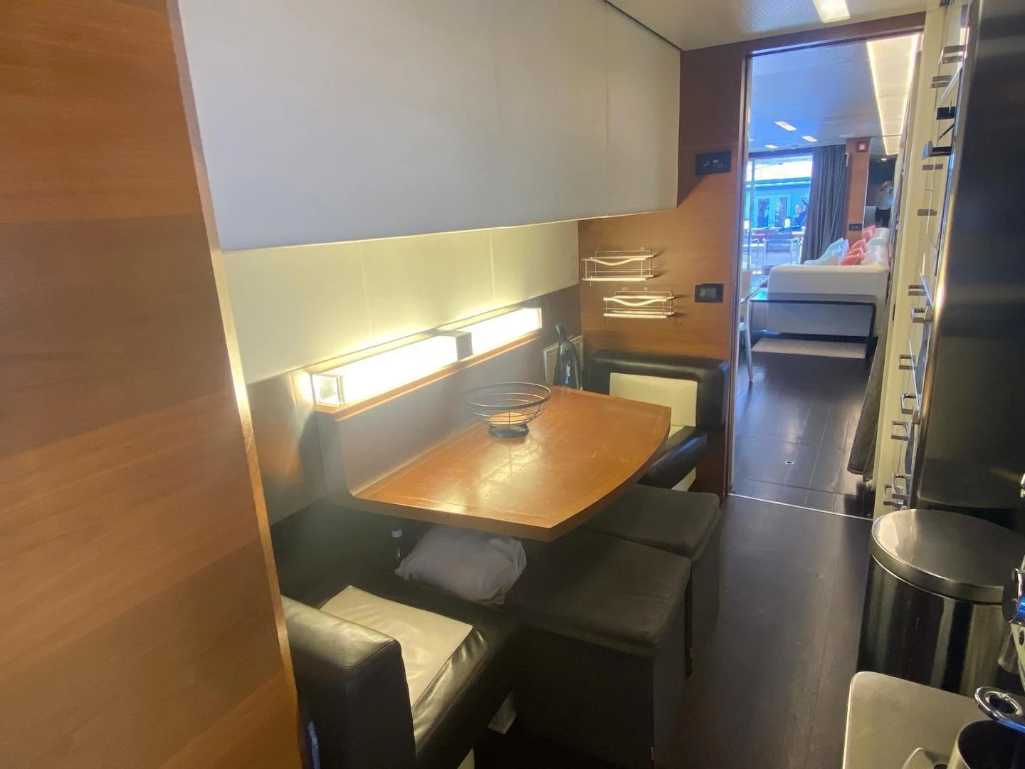 a kitchen with a table and chairs aboard LA TACHE Yacht for Sale
