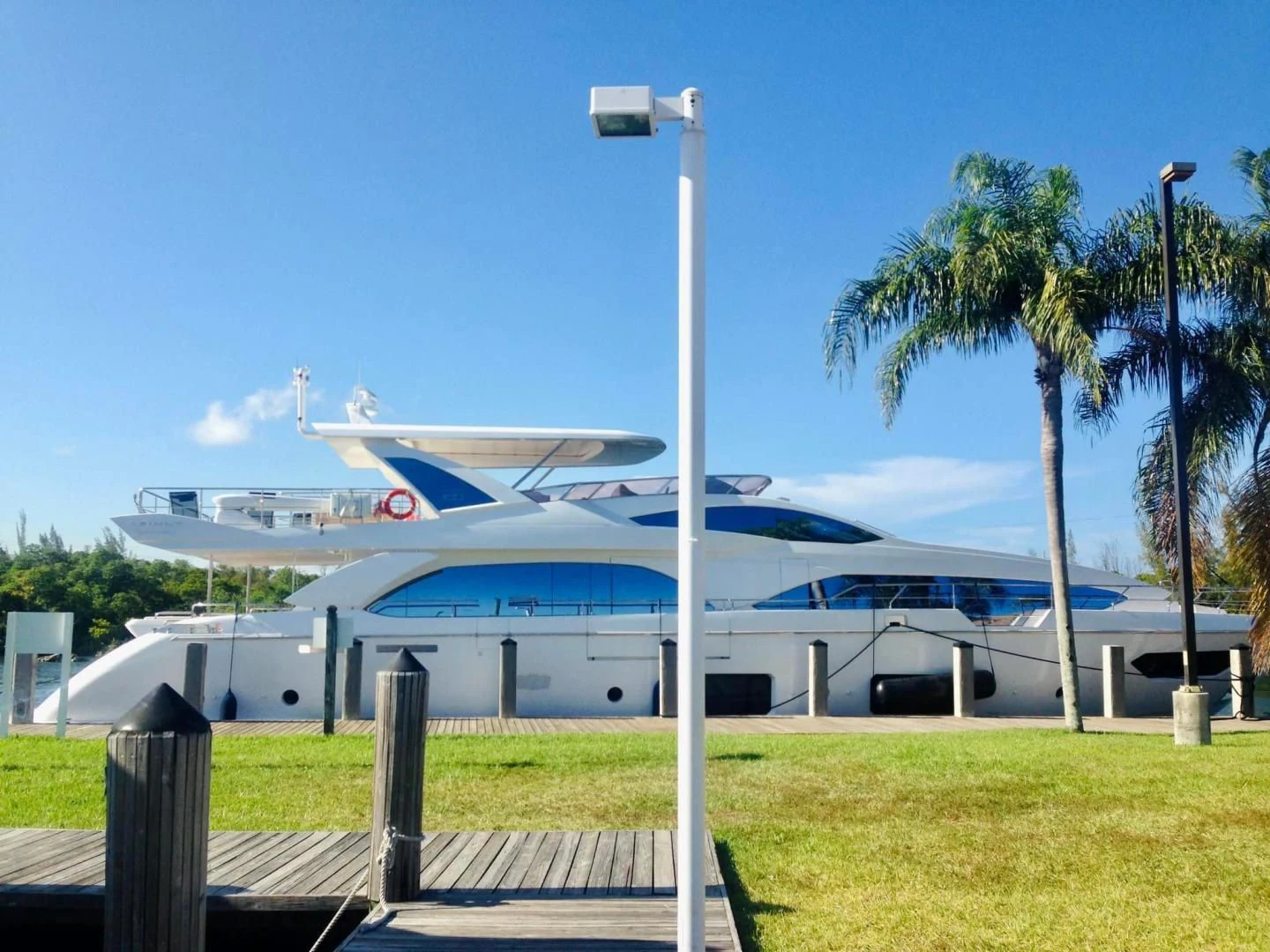 a large white boat with palm trees aboard LA TACHE Yacht for Sale