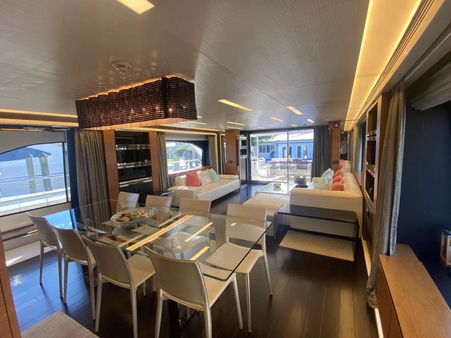 a room with tables and chairs aboard LA TACHE Yacht for Sale