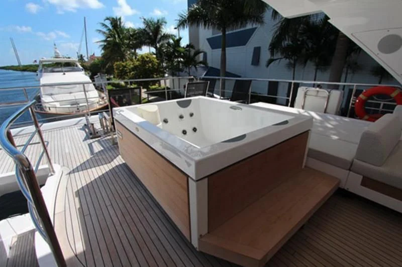 a white boat on a deck aboard LA TACHE Yacht for Sale