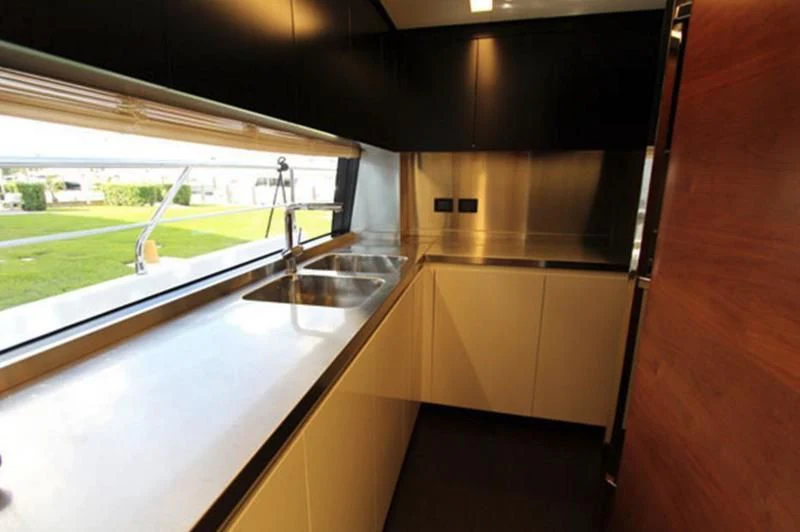 a kitchen with a sink and a window aboard LA TACHE Yacht for Sale