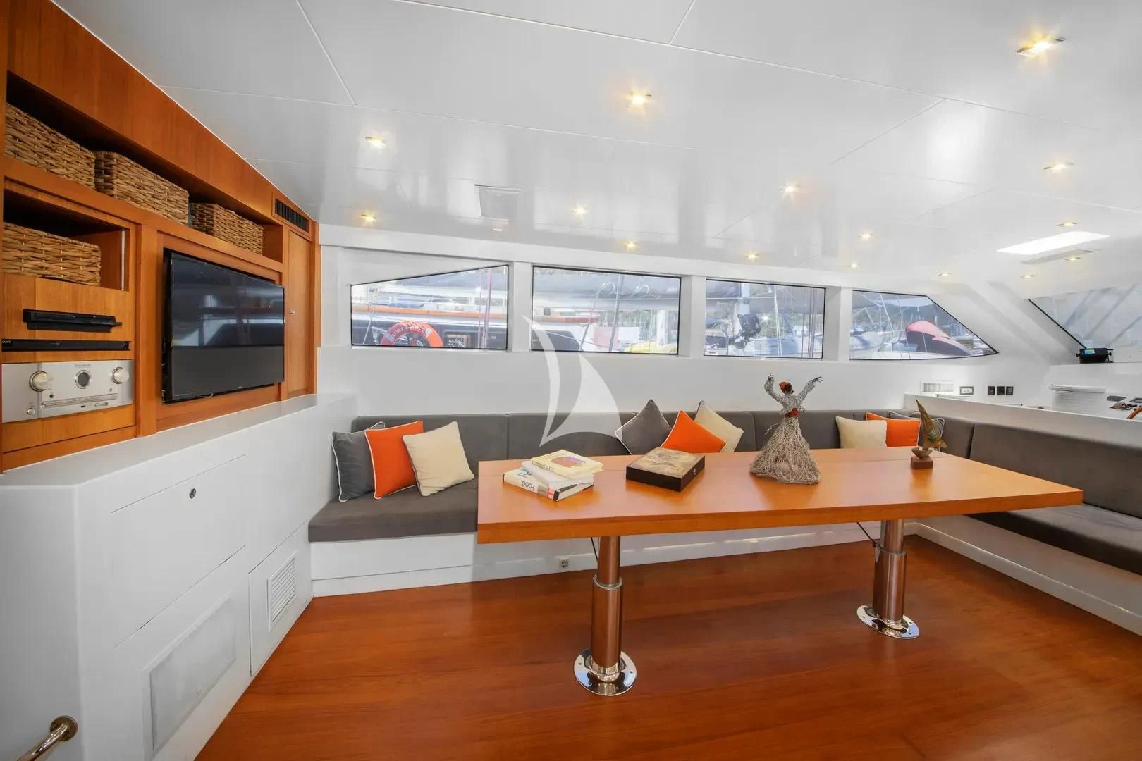 a room with a table and couches aboard UBI BENE Yacht for Charter