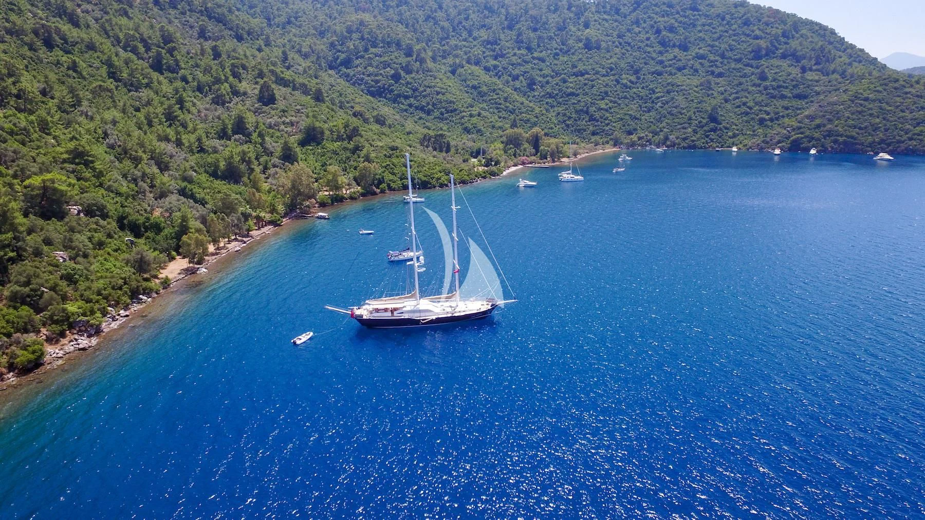 a group of boats in a body of water aboard UBI BENE Yacht for Charter