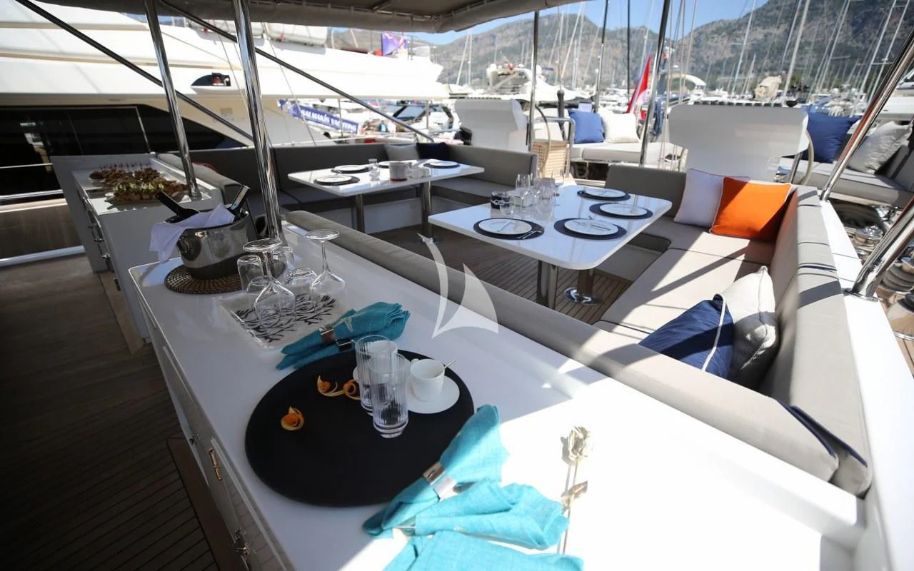 a boat with a table and chairs aboard UBI BENE Yacht for Charter