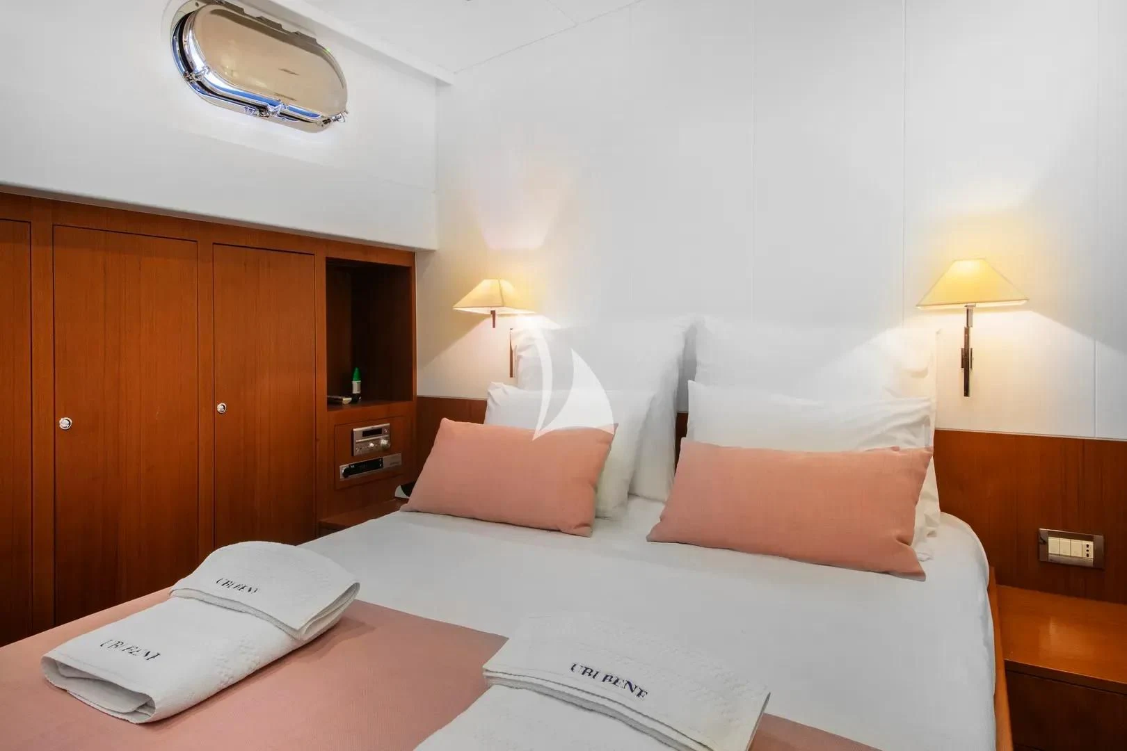 a hotel room with a bed and a desk aboard UBI BENE Yacht for Charter