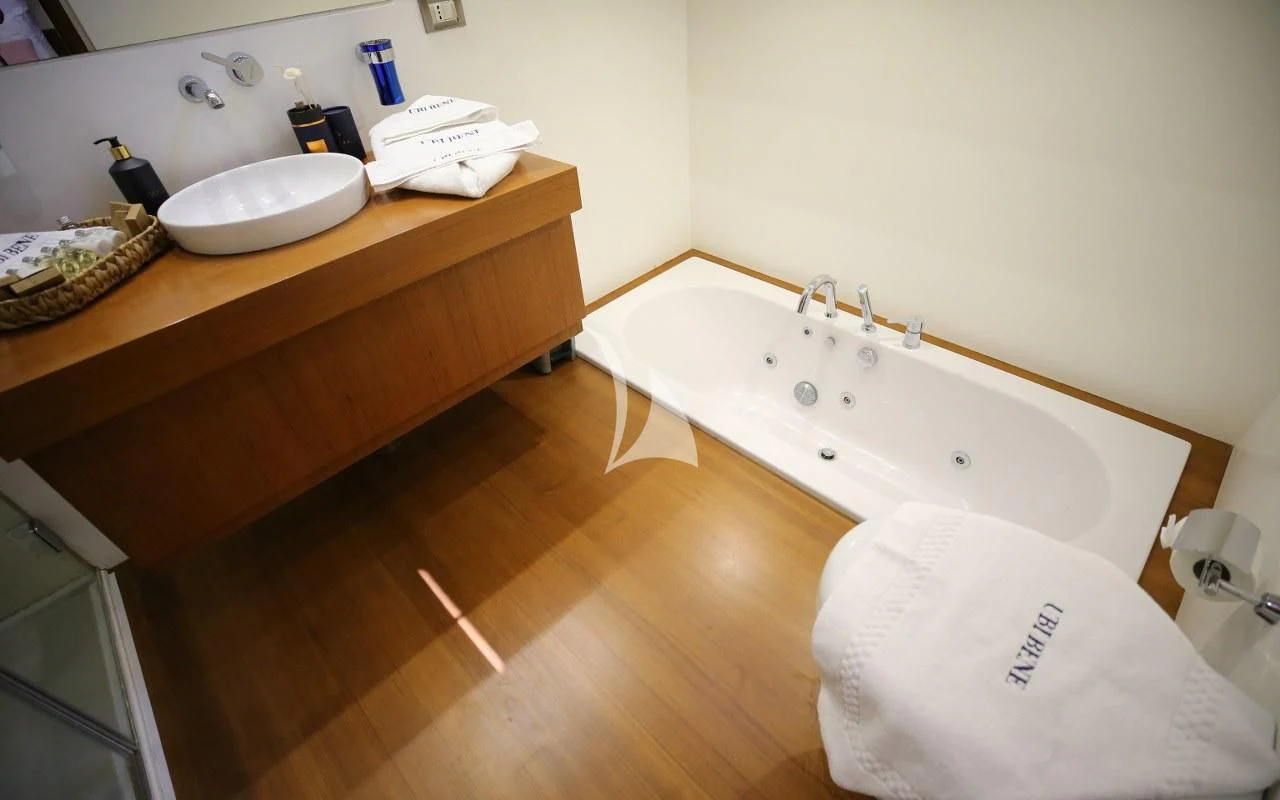 a bathroom with a bathtub sink and a sink aboard UBI BENE Yacht for Charter