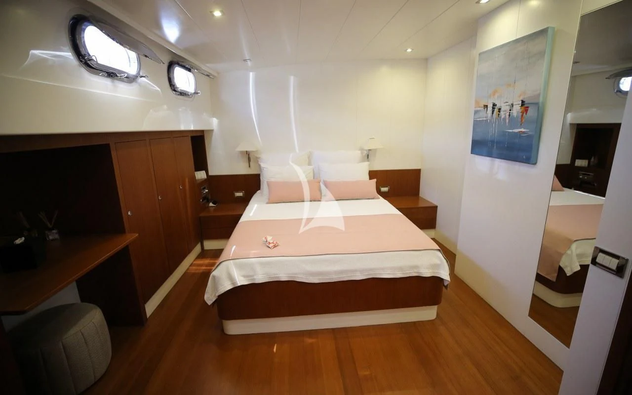 a room with a bed and a desk aboard UBI BENE Yacht for Charter