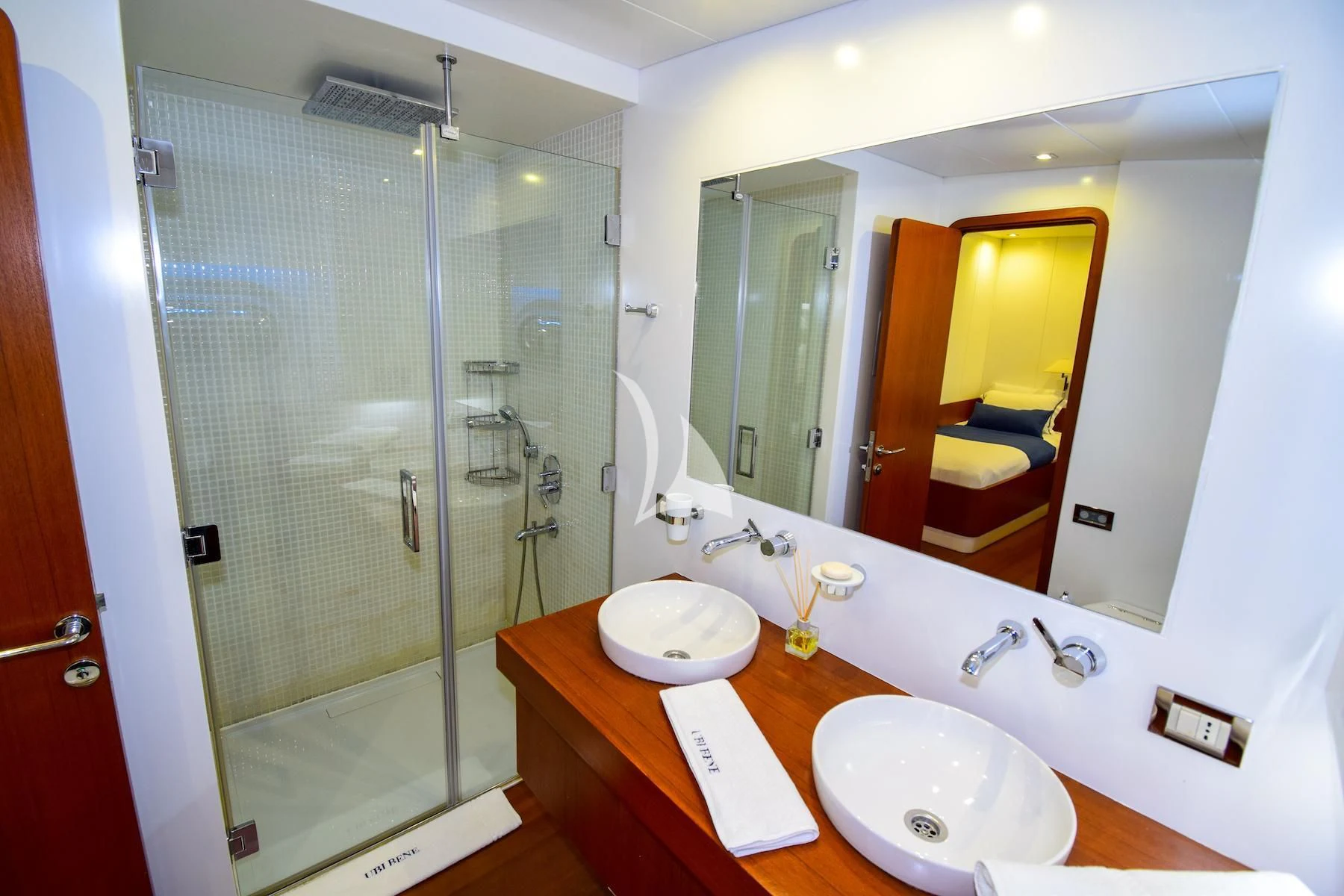 a bathroom with a large mirror aboard UBI BENE Yacht for Charter