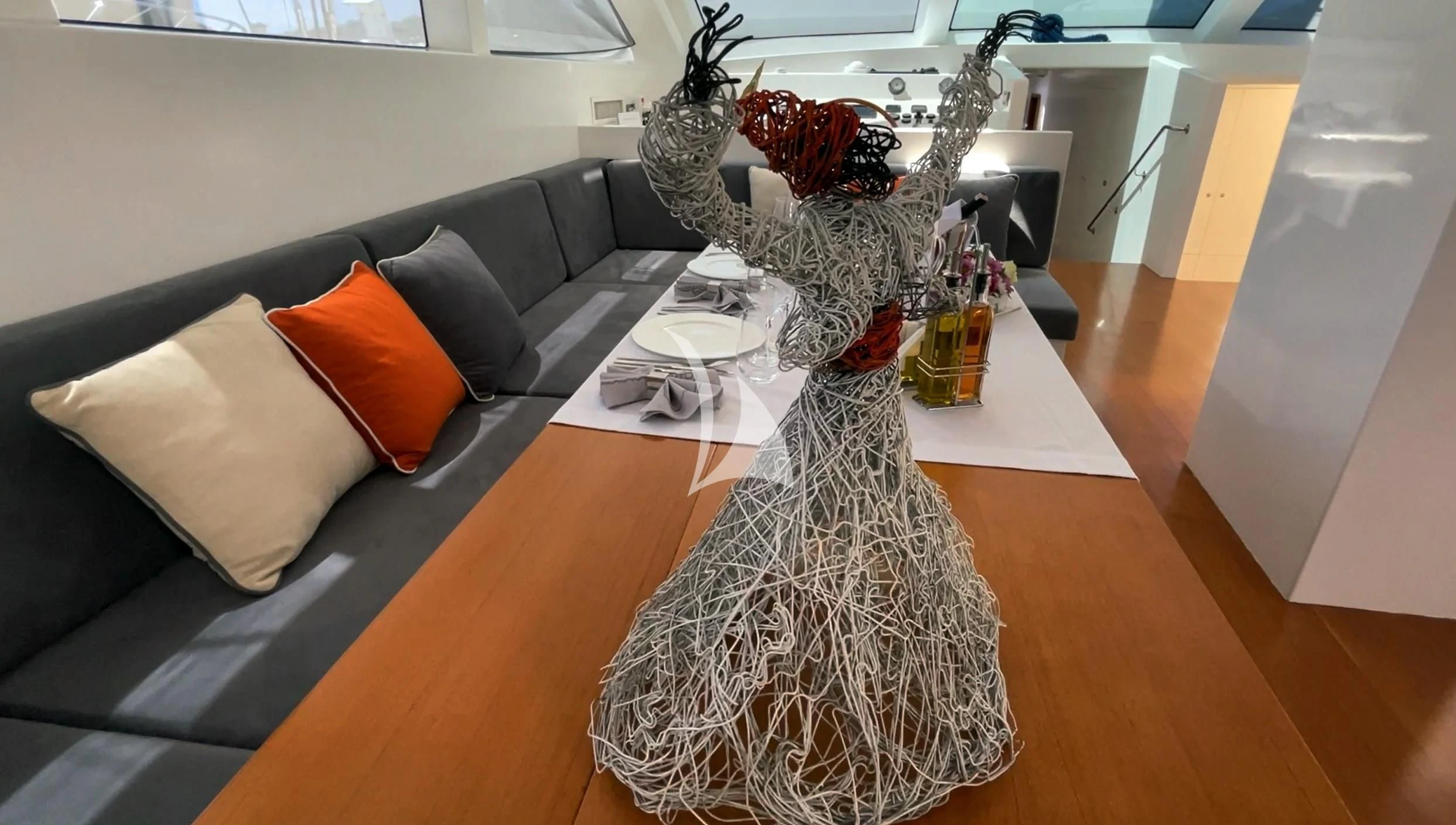 a stuffed animal on a couch aboard UBI BENE Yacht for Charter