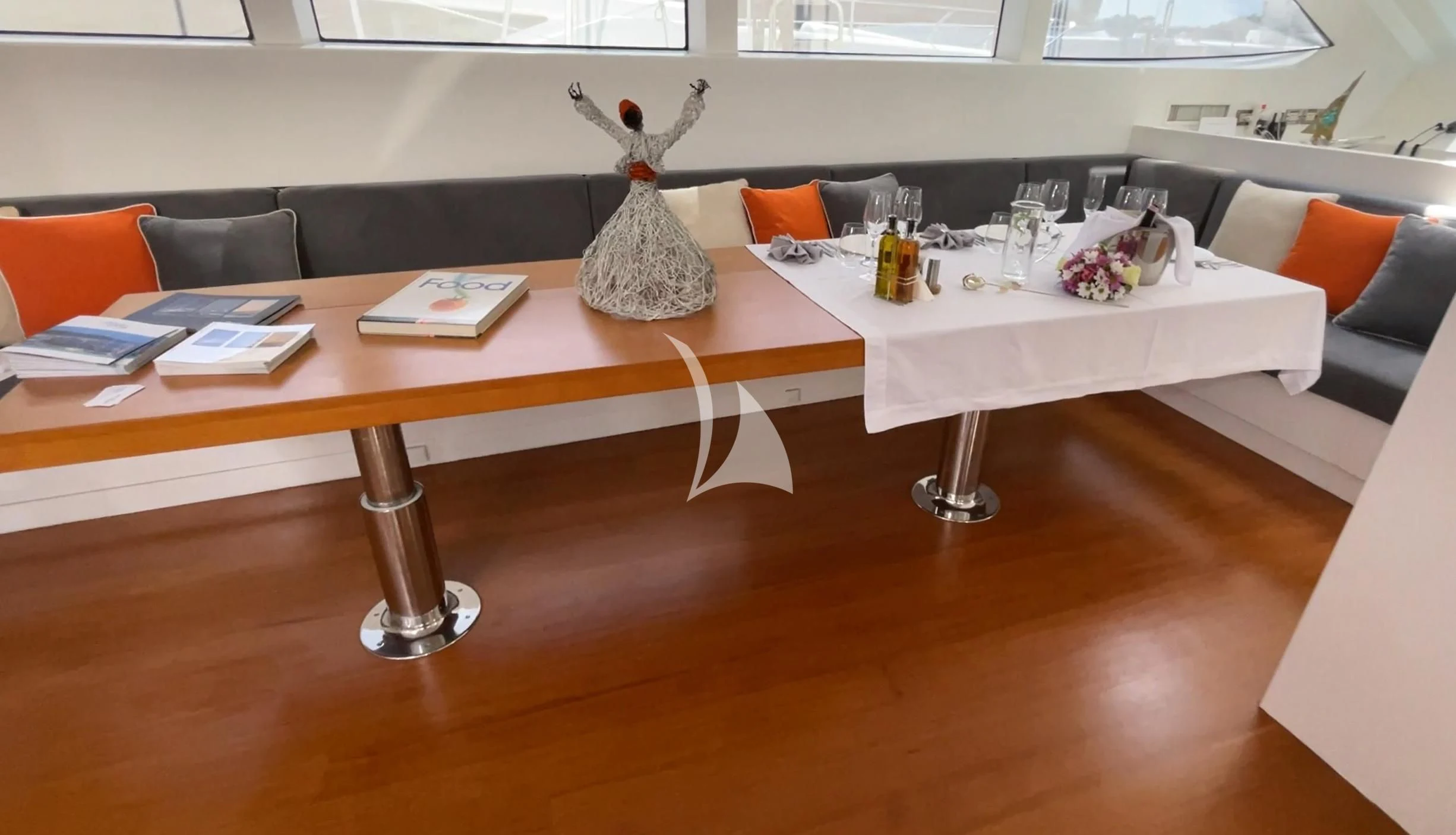 a table with a vase and a bottle on it aboard UBI BENE Yacht for Charter