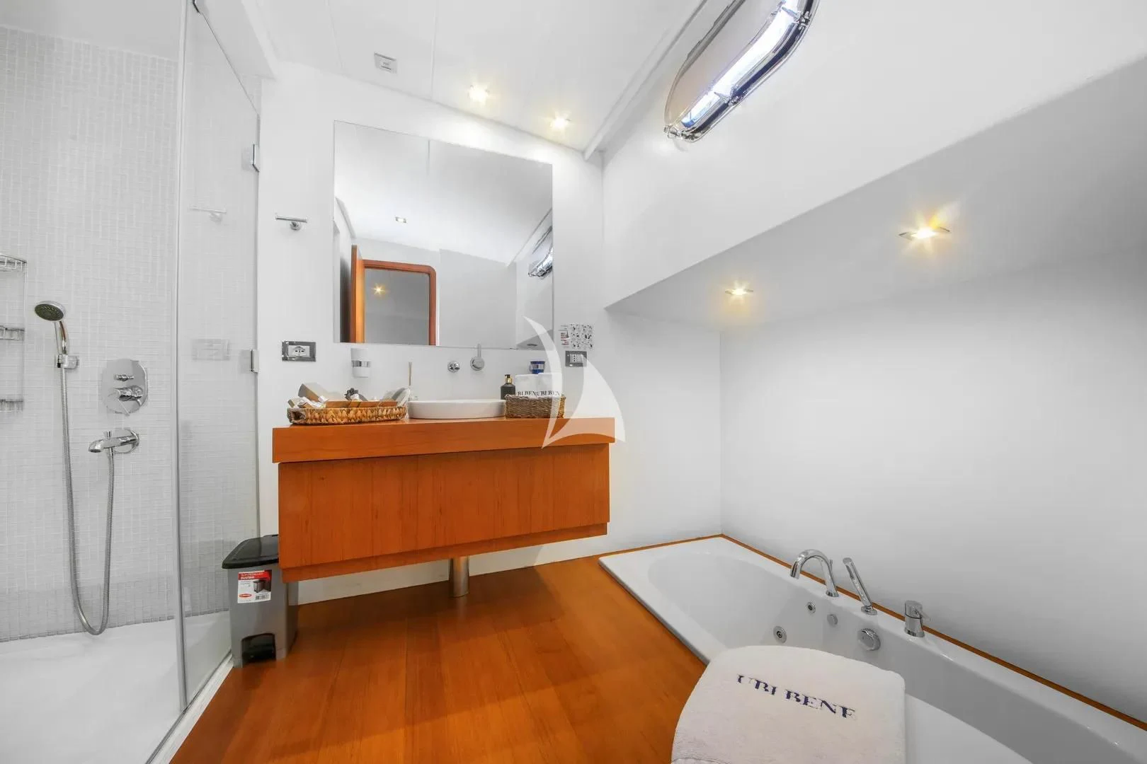 a bathroom with a tub sink and a shower unit aboard UBI BENE Yacht for Charter