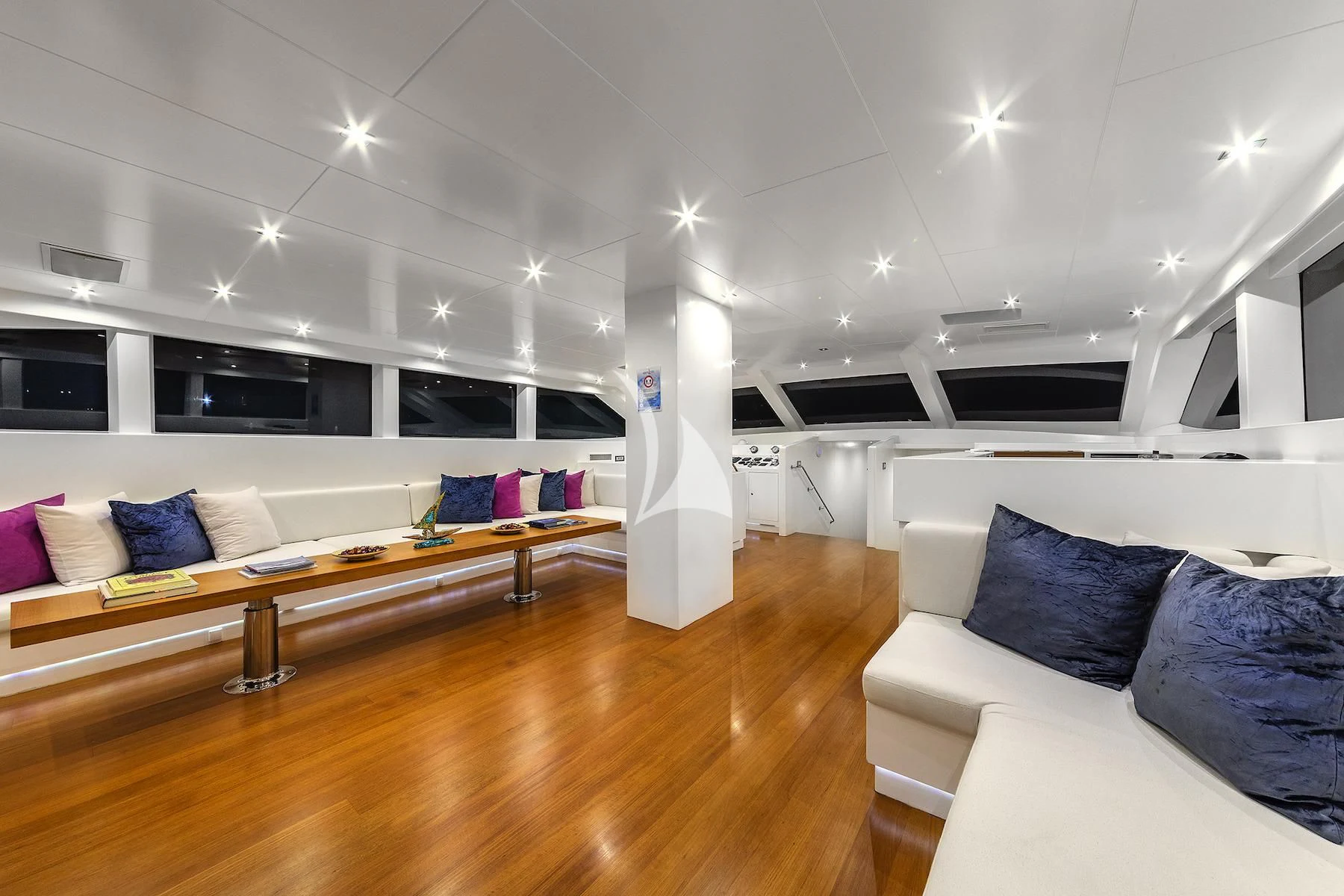 a room with a couch and a table and a large white pillar aboard UBI BENE Yacht for Charter