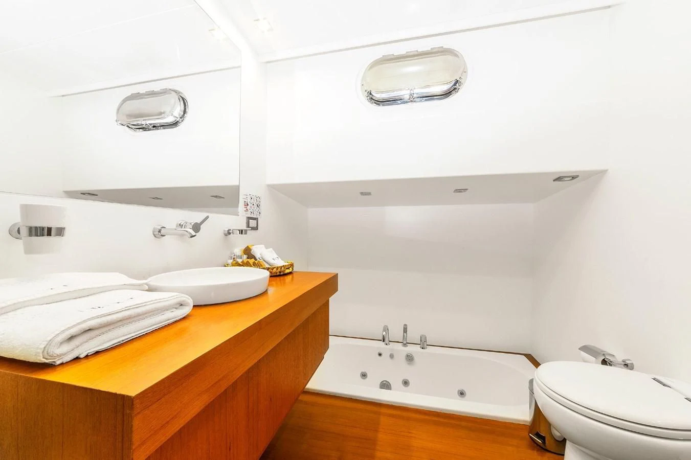 a bathroom with a toilet sink and a mirror aboard UBI BENE Yacht for Charter