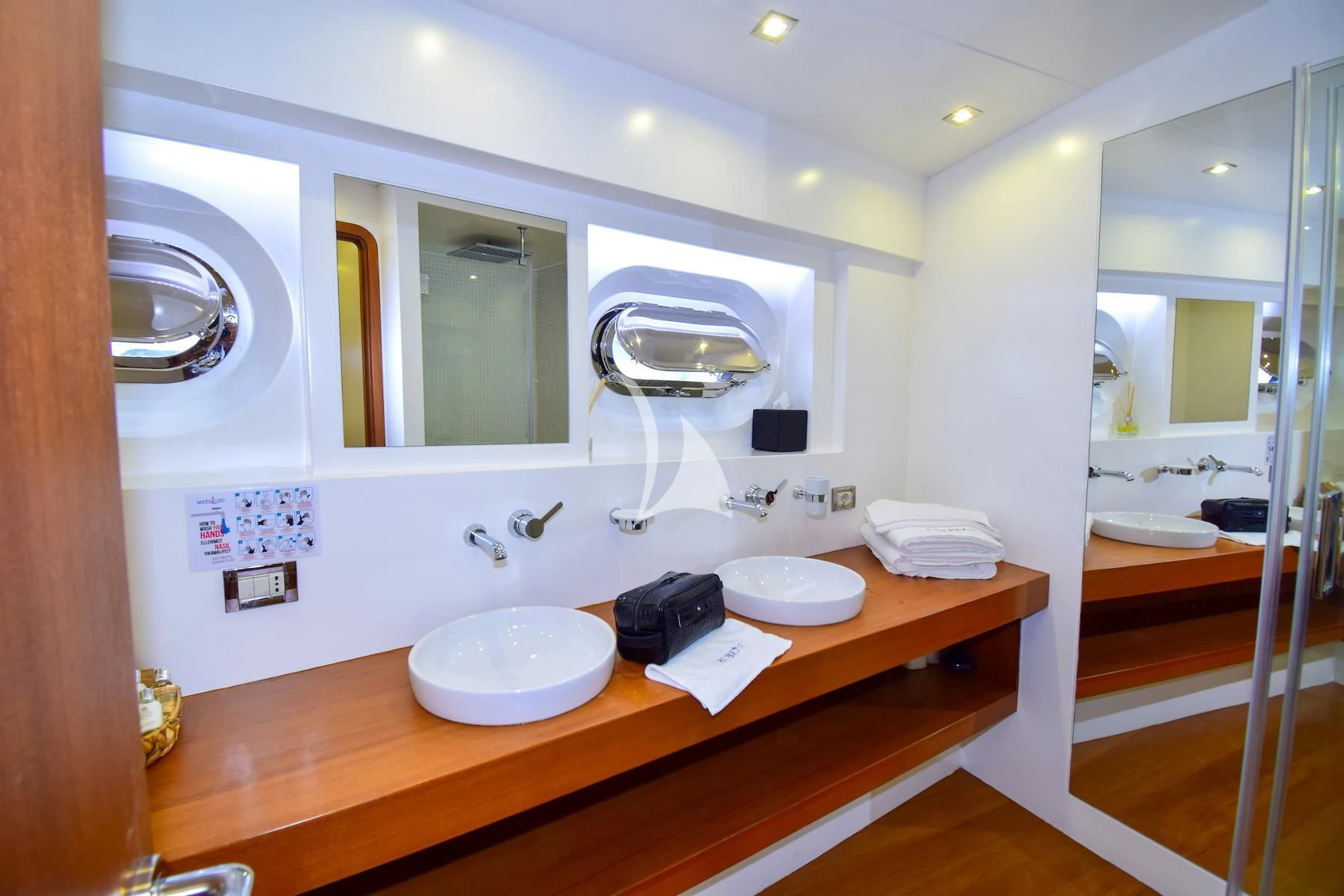 a bathroom with a sink and a mirror aboard UBI BENE Yacht for Charter
