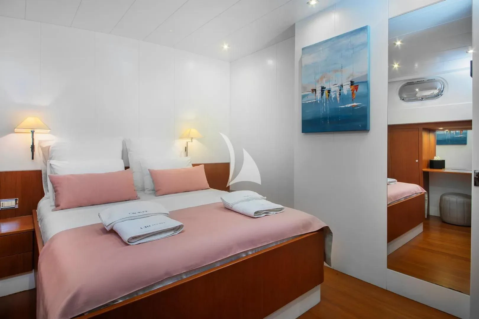 a bed with a book on it aboard UBI BENE Yacht for Charter