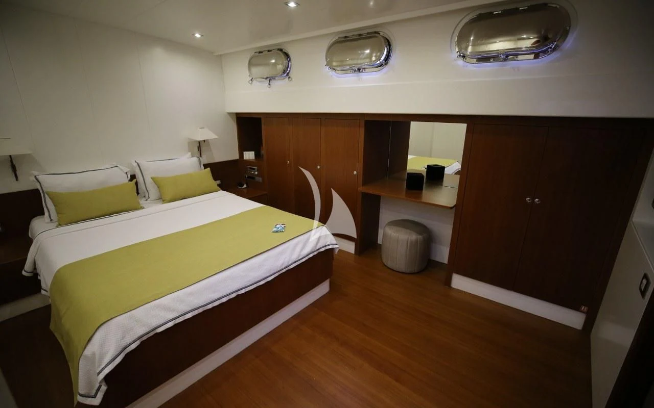 a room with a bed and a desk aboard UBI BENE Yacht for Charter