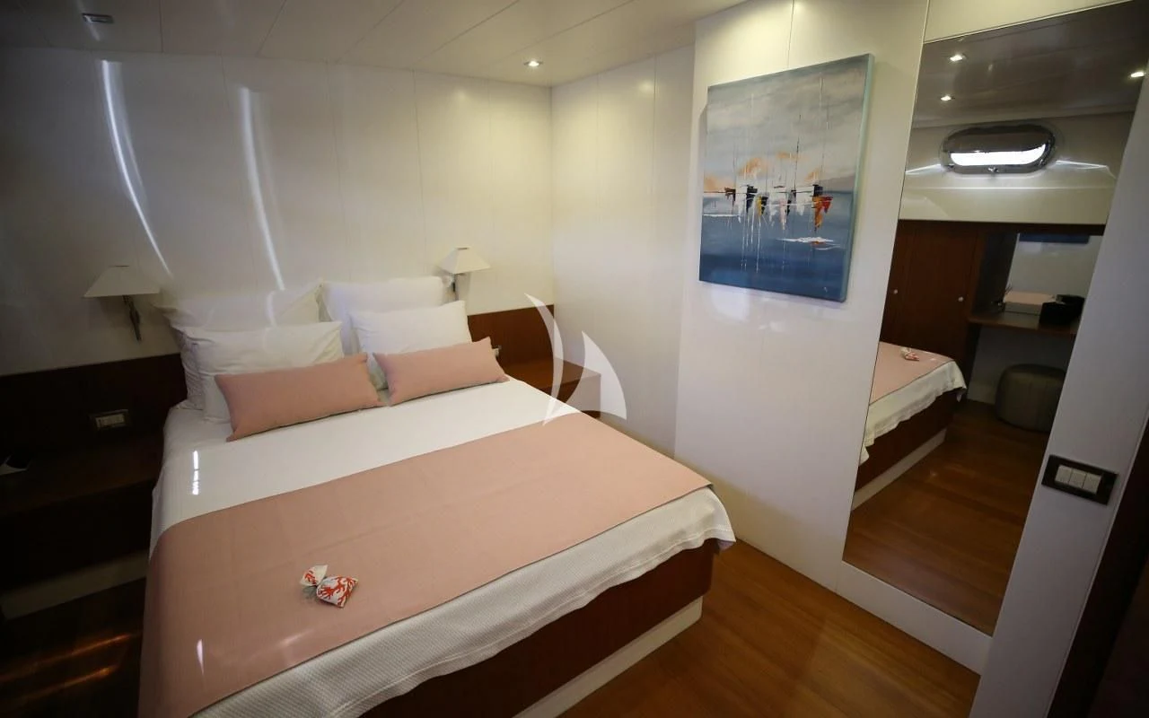 a room with a bed and a desk aboard UBI BENE Yacht for Charter