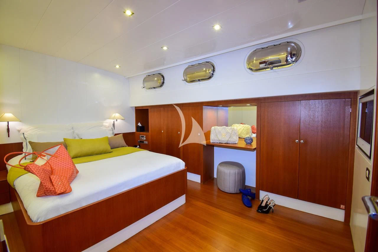 a bedroom with a bed and a desk aboard UBI BENE Yacht for Charter