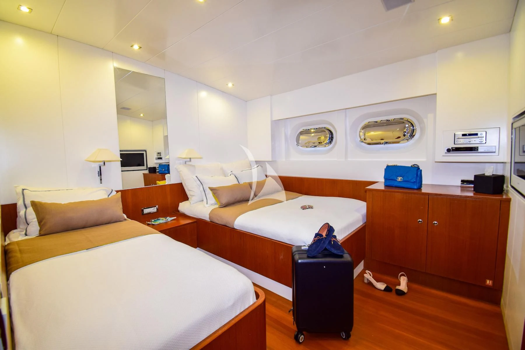 a room with beds and a tv aboard UBI BENE Yacht for Charter