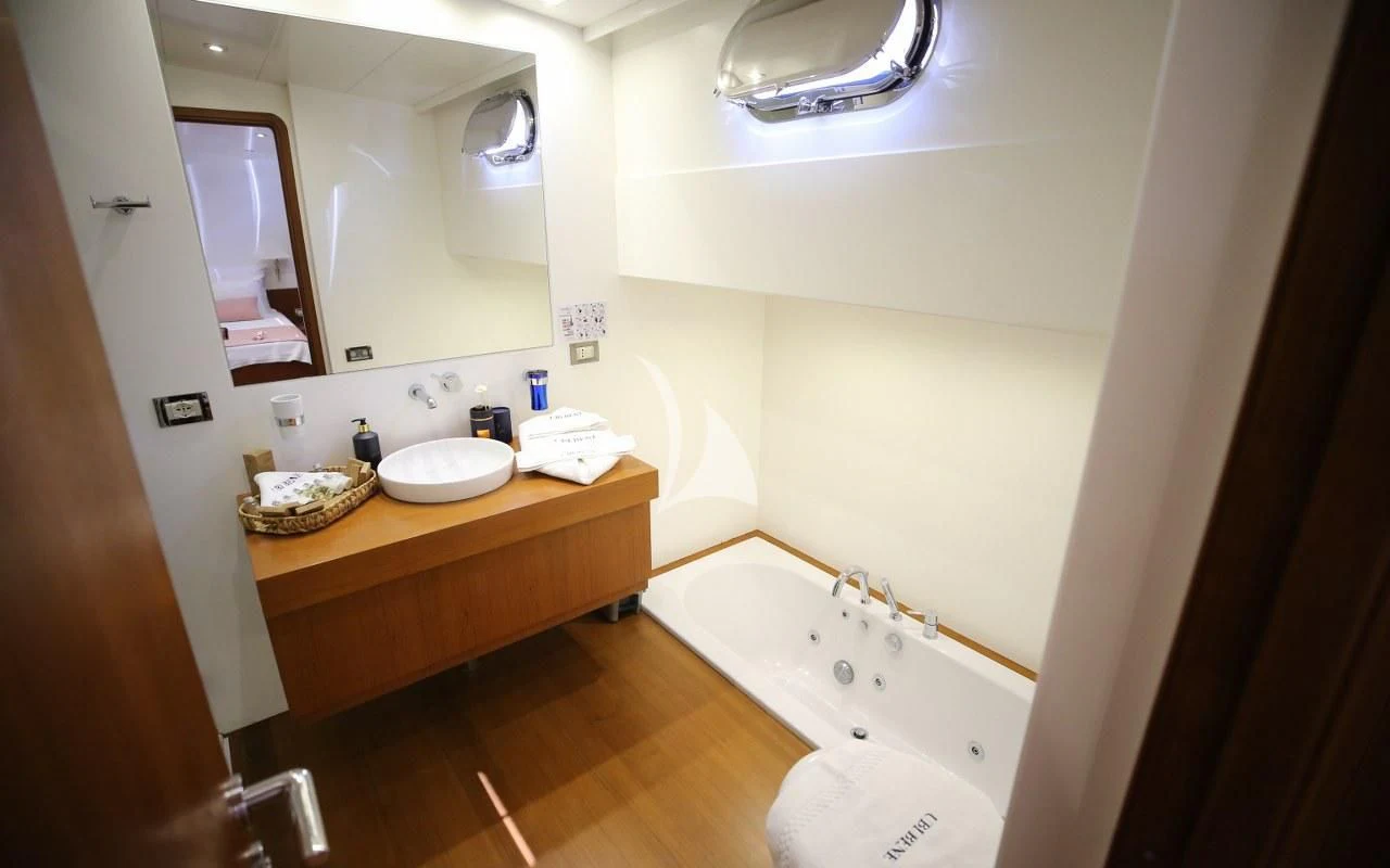 a bathroom with a sink and tub aboard UBI BENE Yacht for Charter