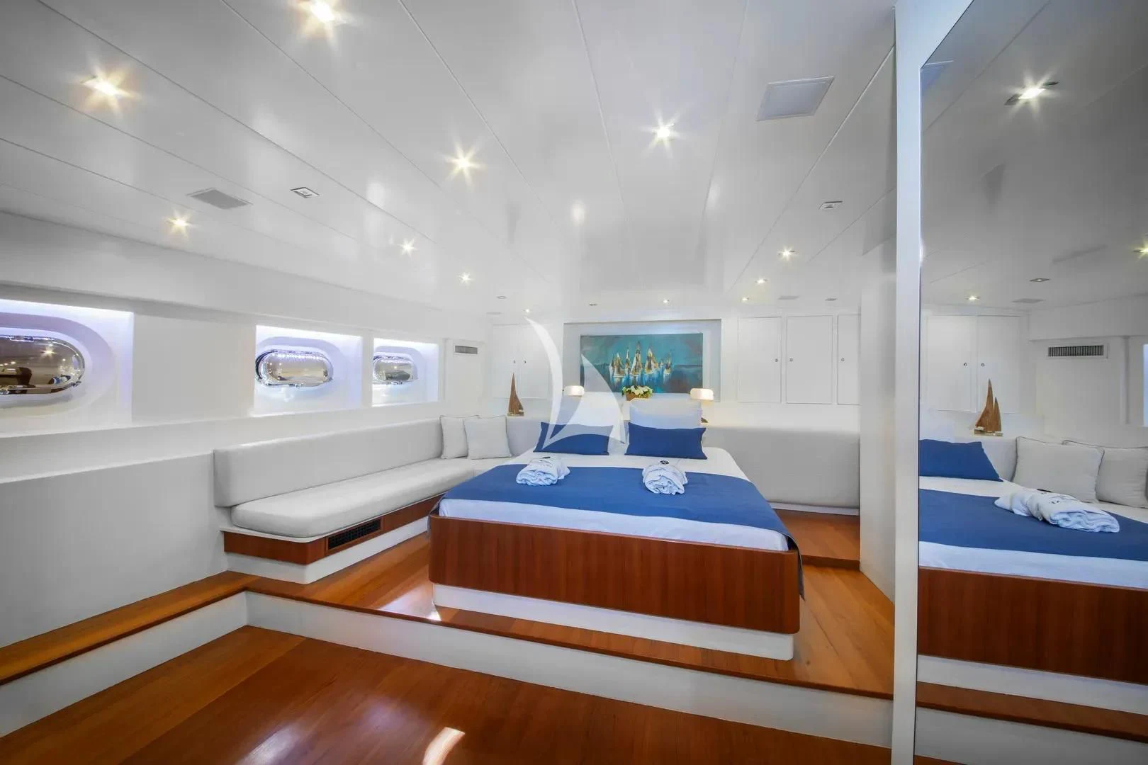 a room with a bed and a mirror aboard UBI BENE Yacht for Charter