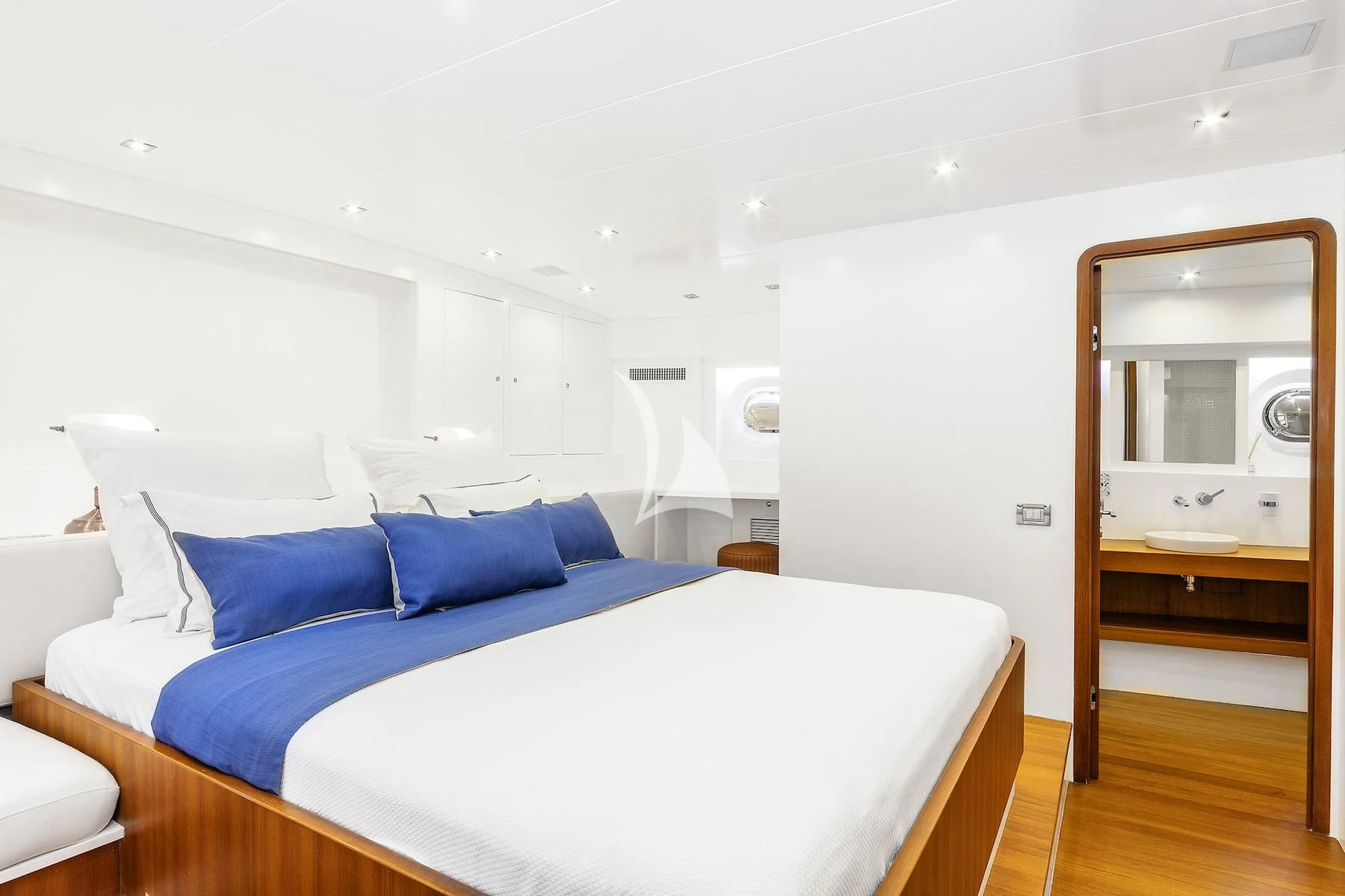 a bed with a blue pillow aboard UBI BENE Yacht for Charter