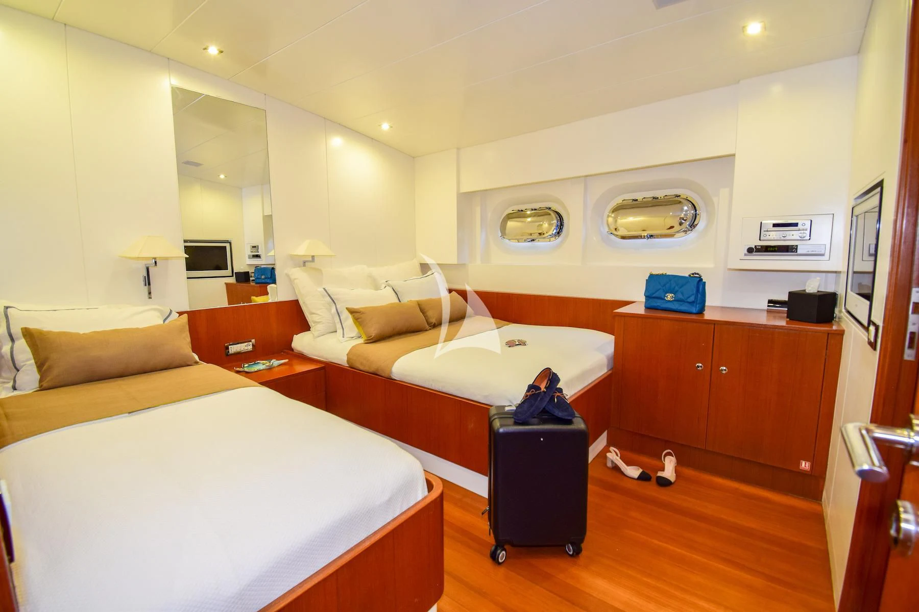 a bedroom with a bed and a desk aboard UBI BENE Yacht for Charter