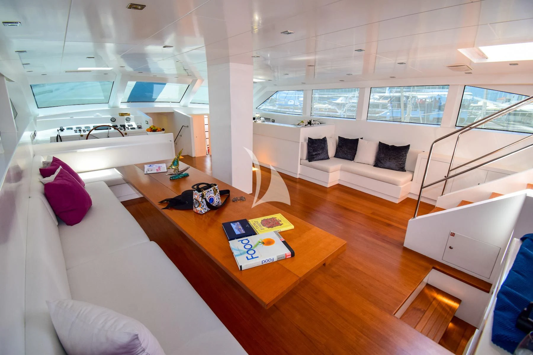 a room with a table and a couch aboard UBI BENE Yacht for Charter