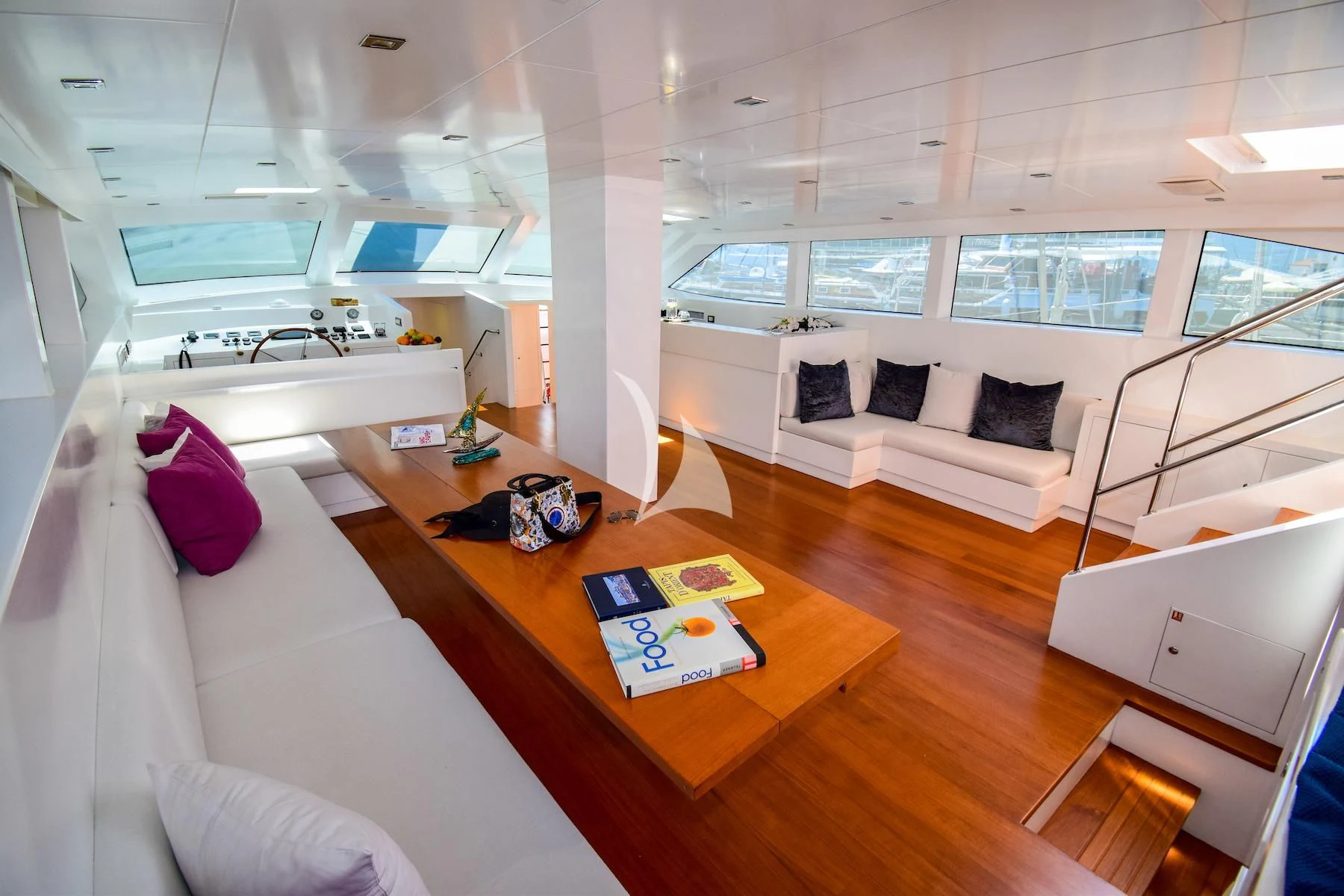 a room with a table and couch aboard UBI BENE Yacht for Charter
