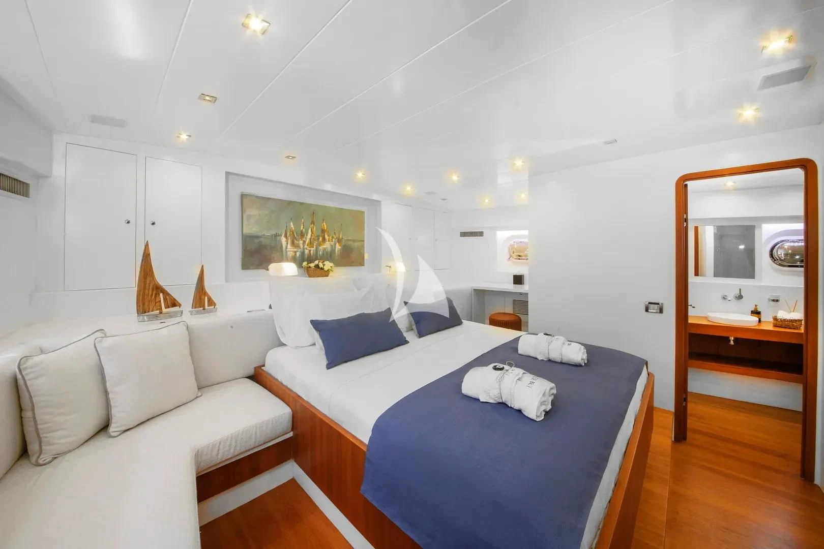 a bedroom with a bed and a couch aboard UBI BENE Yacht for Charter