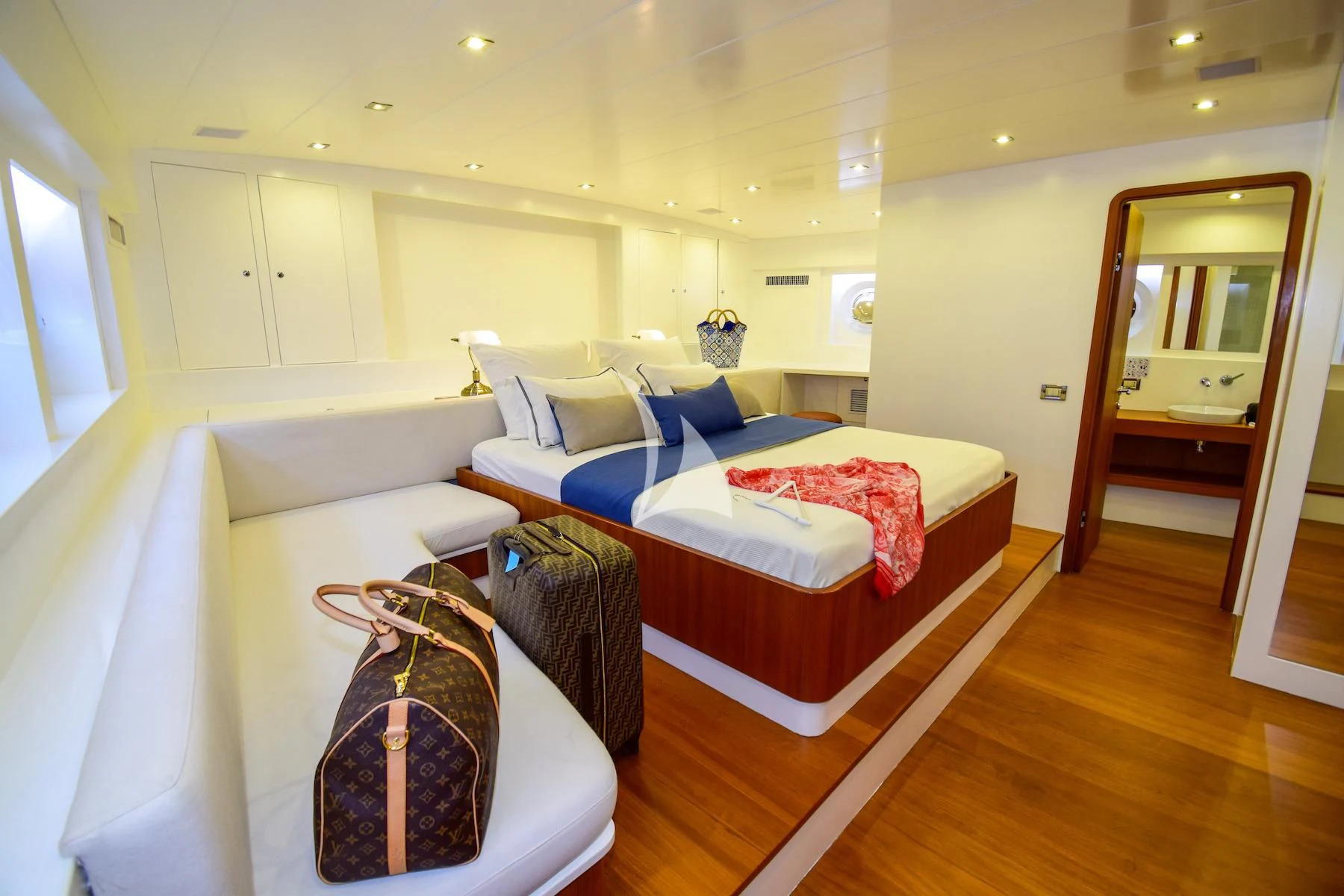 a room with a bed and a mirror aboard UBI BENE Yacht for Charter
