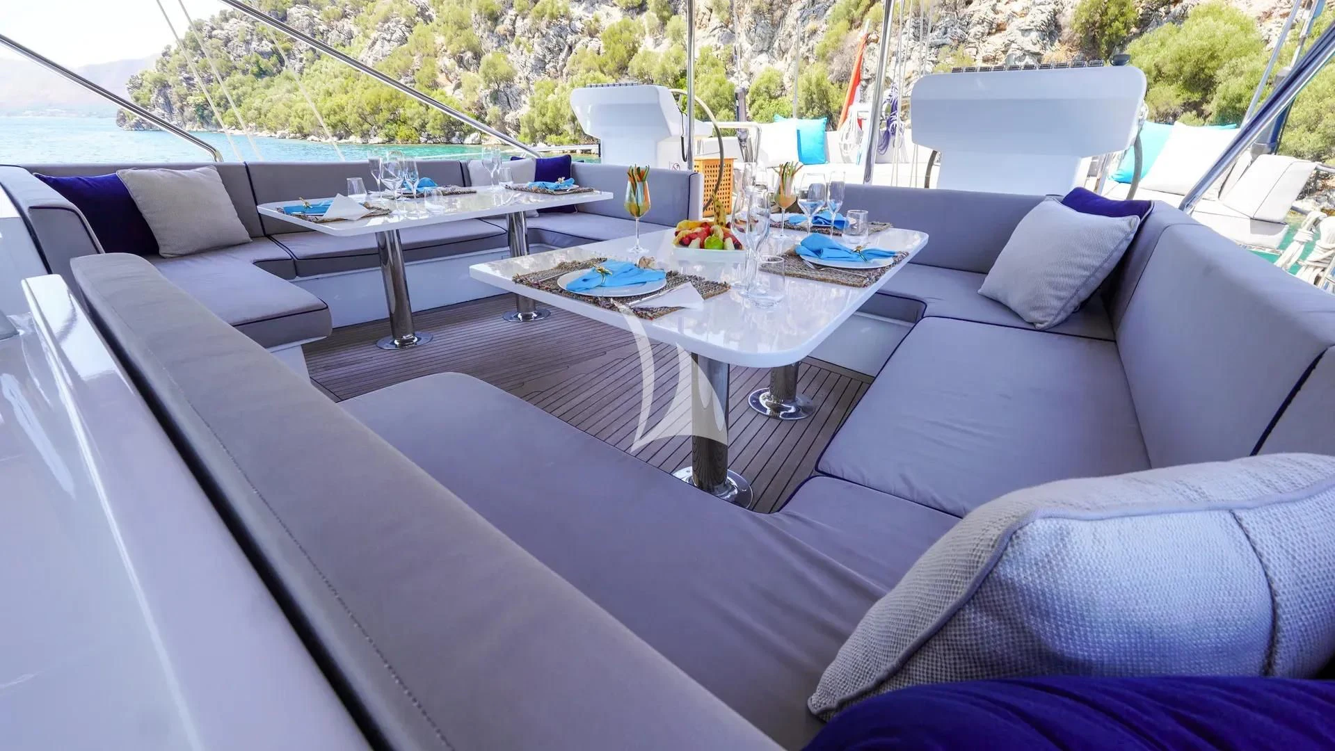 a white couch with a table and chairs on it aboard UBI BENE Yacht for Charter