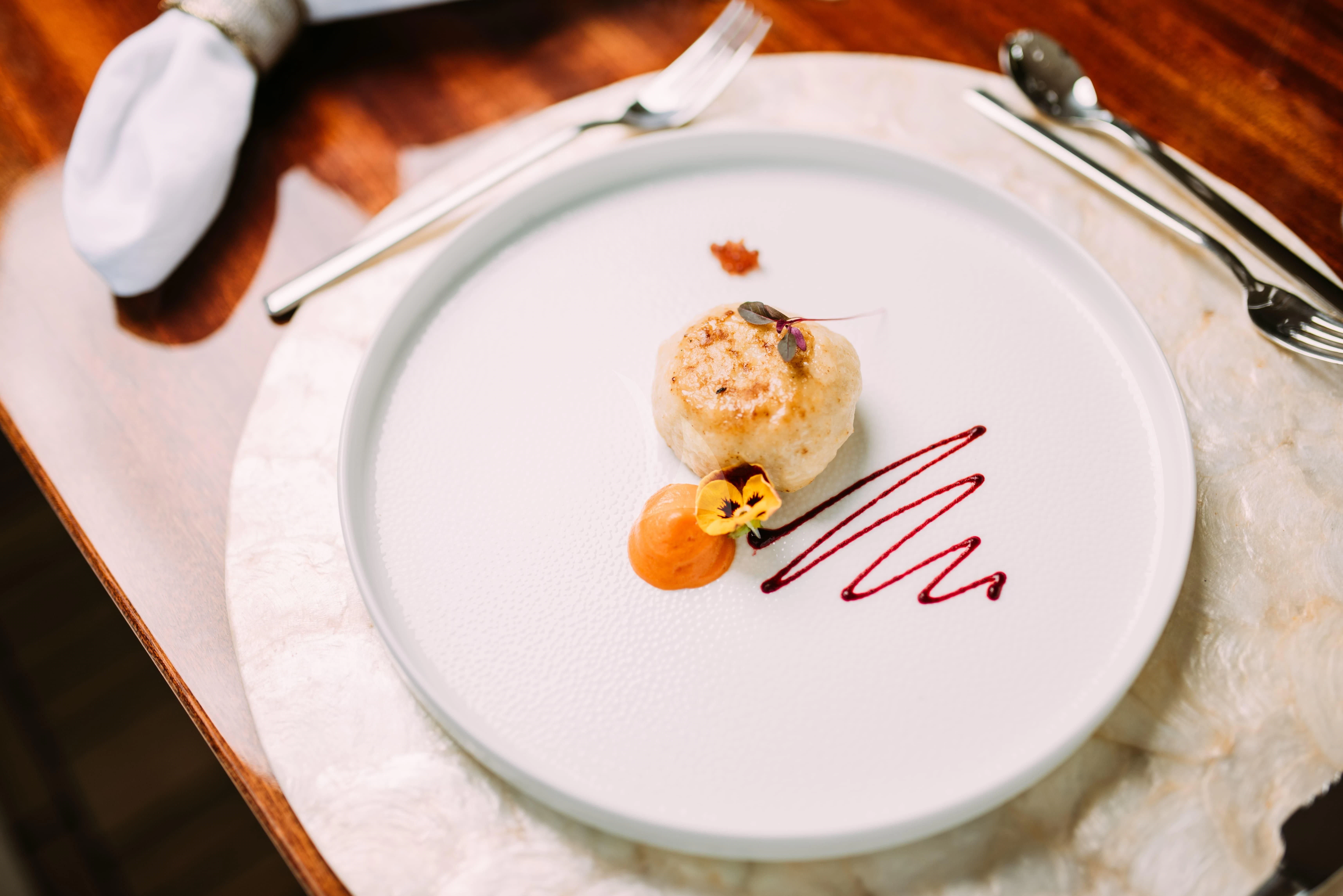 a plate with a piece of cake on it aboard TIREA Yacht for Sale