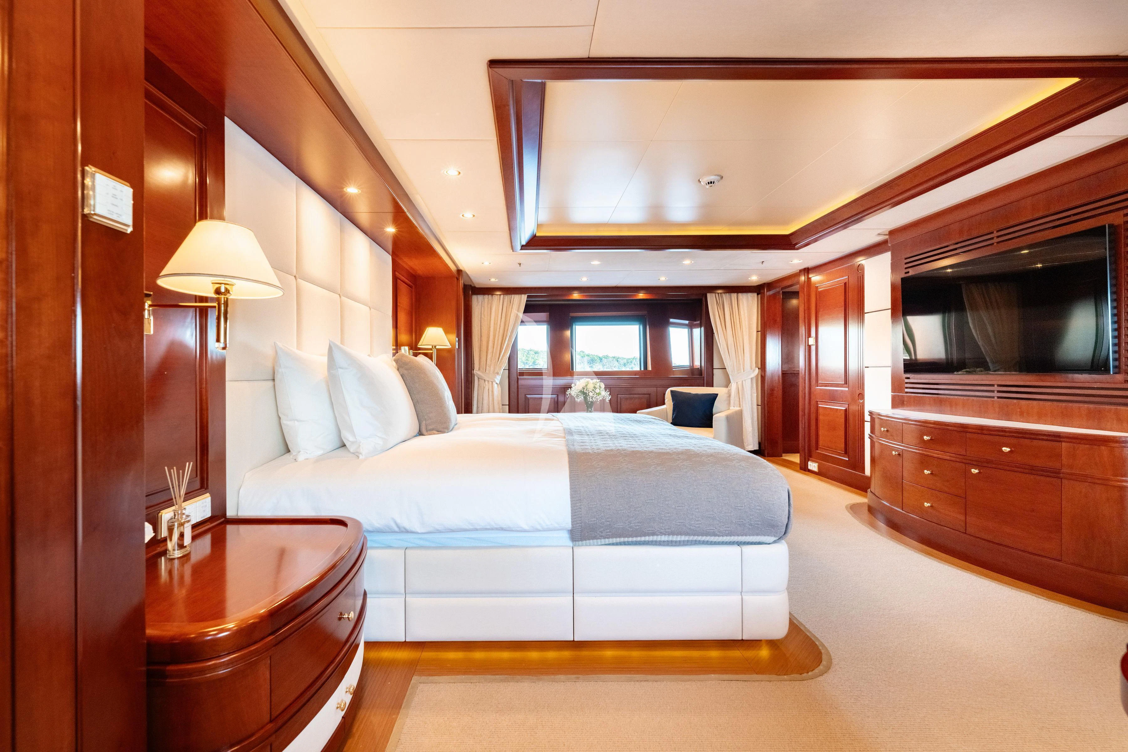 a bedroom with a bed and a television aboard TIREA Yacht for Sale
