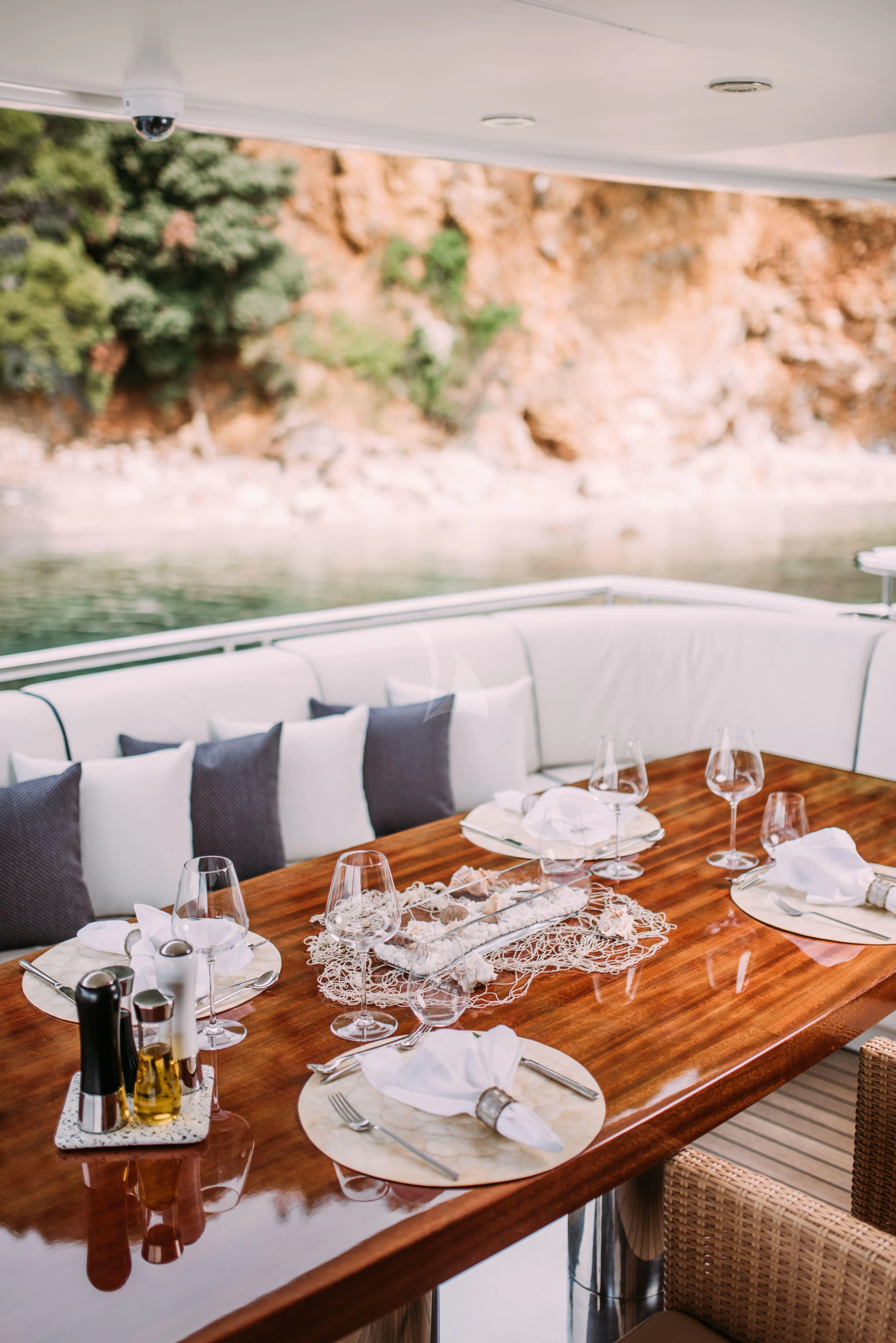 a table with plates and glasses on it aboard TIREA Yacht for Sale