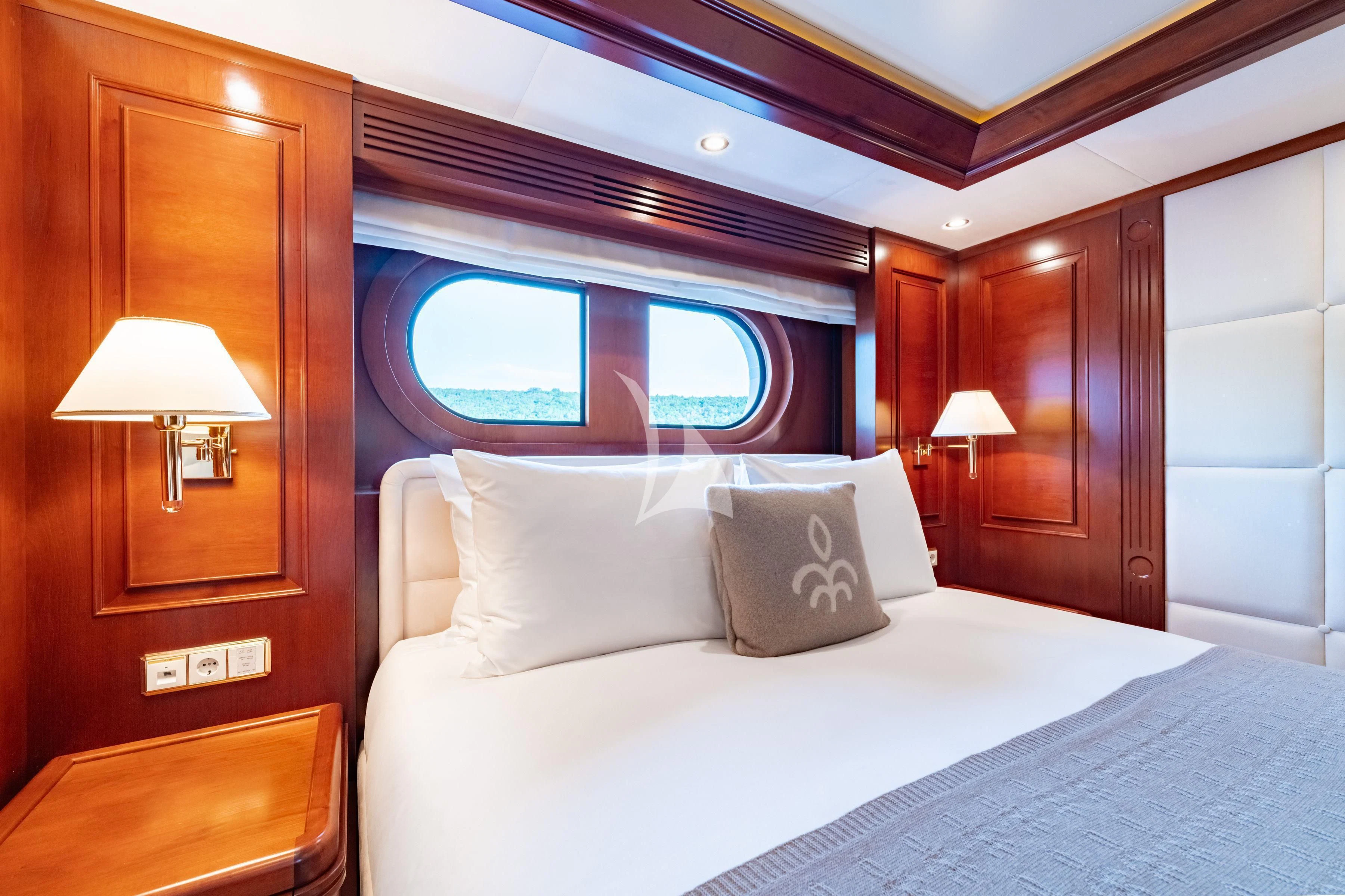a bed with a white bed spread aboard TIREA Yacht for Sale