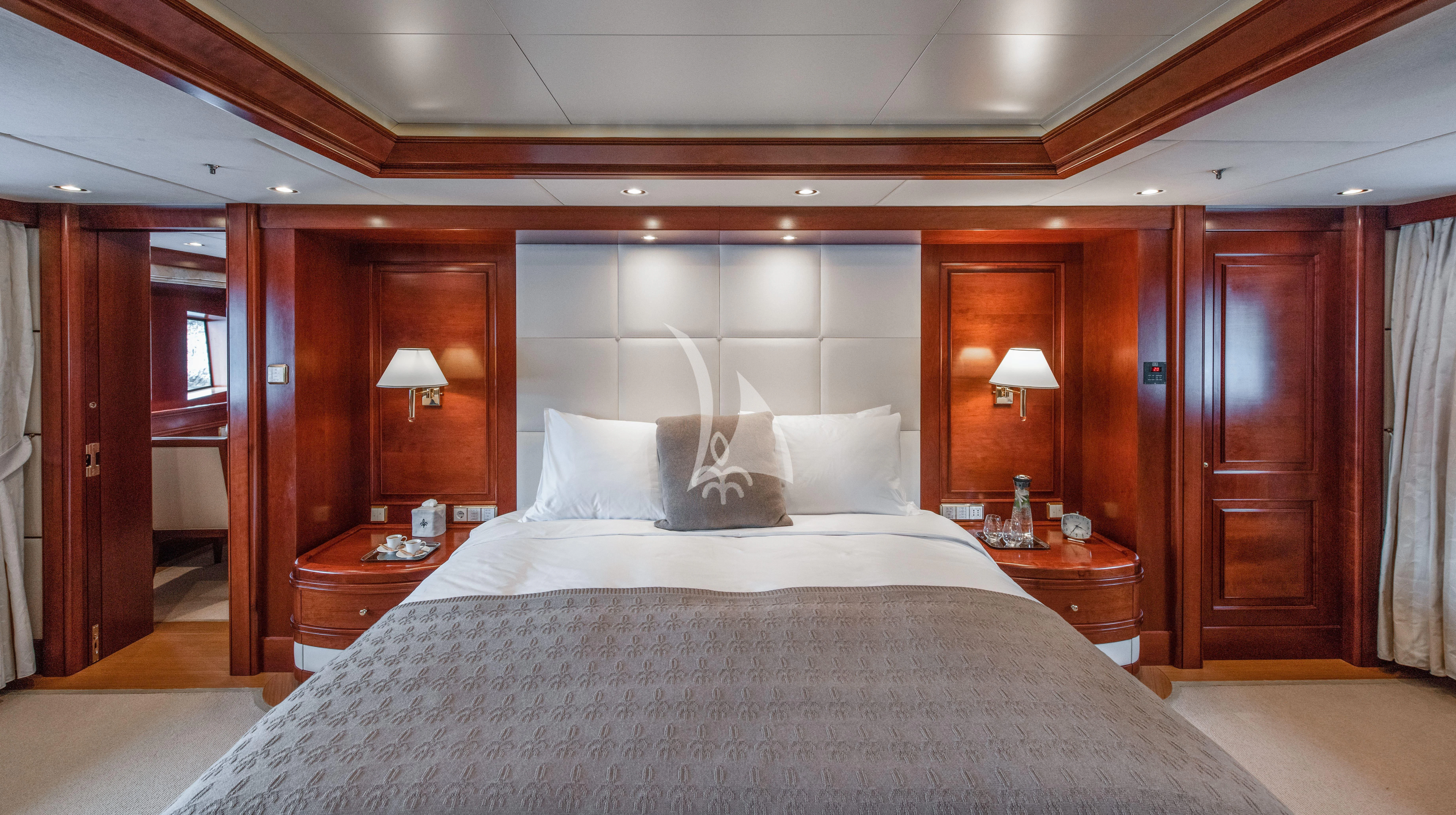 a bed with a white sheet and pillows aboard TIREA Yacht for Sale