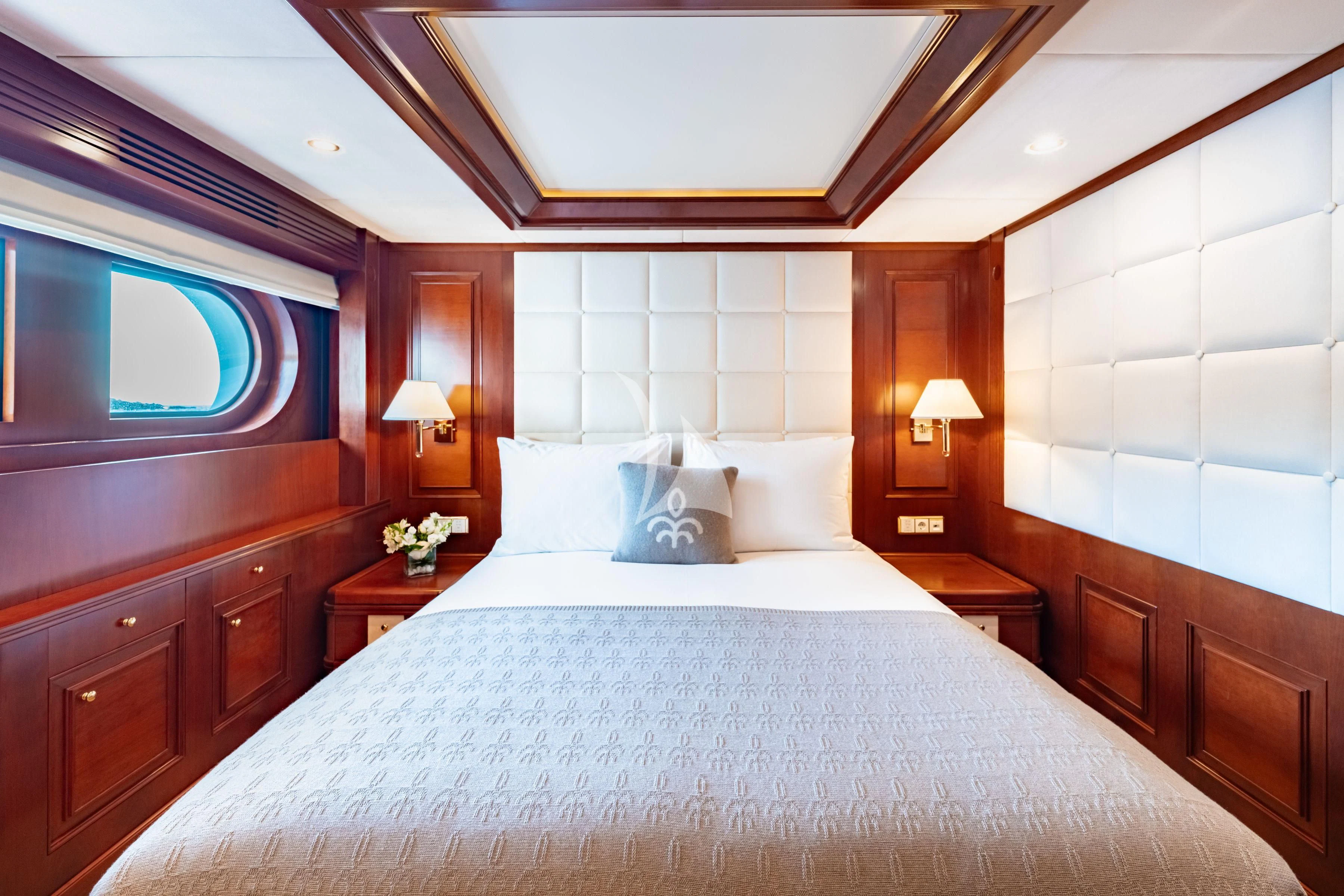 a bed with a white comforter aboard TIREA Yacht for Sale