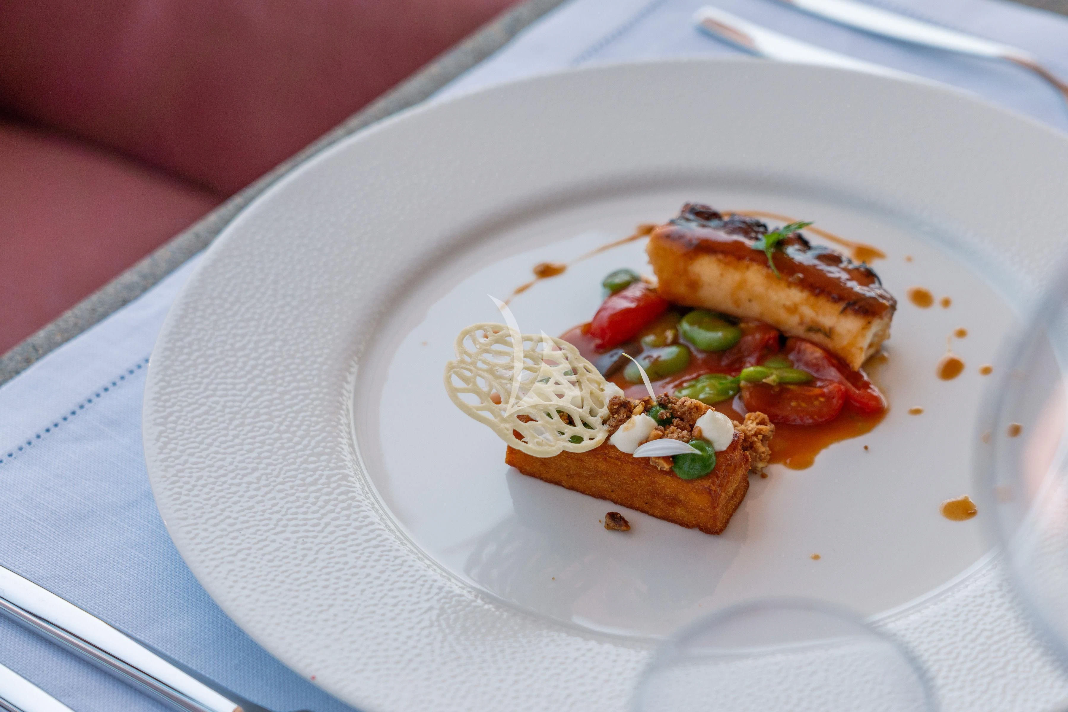 a plate of food aboard TIREA Yacht for Sale