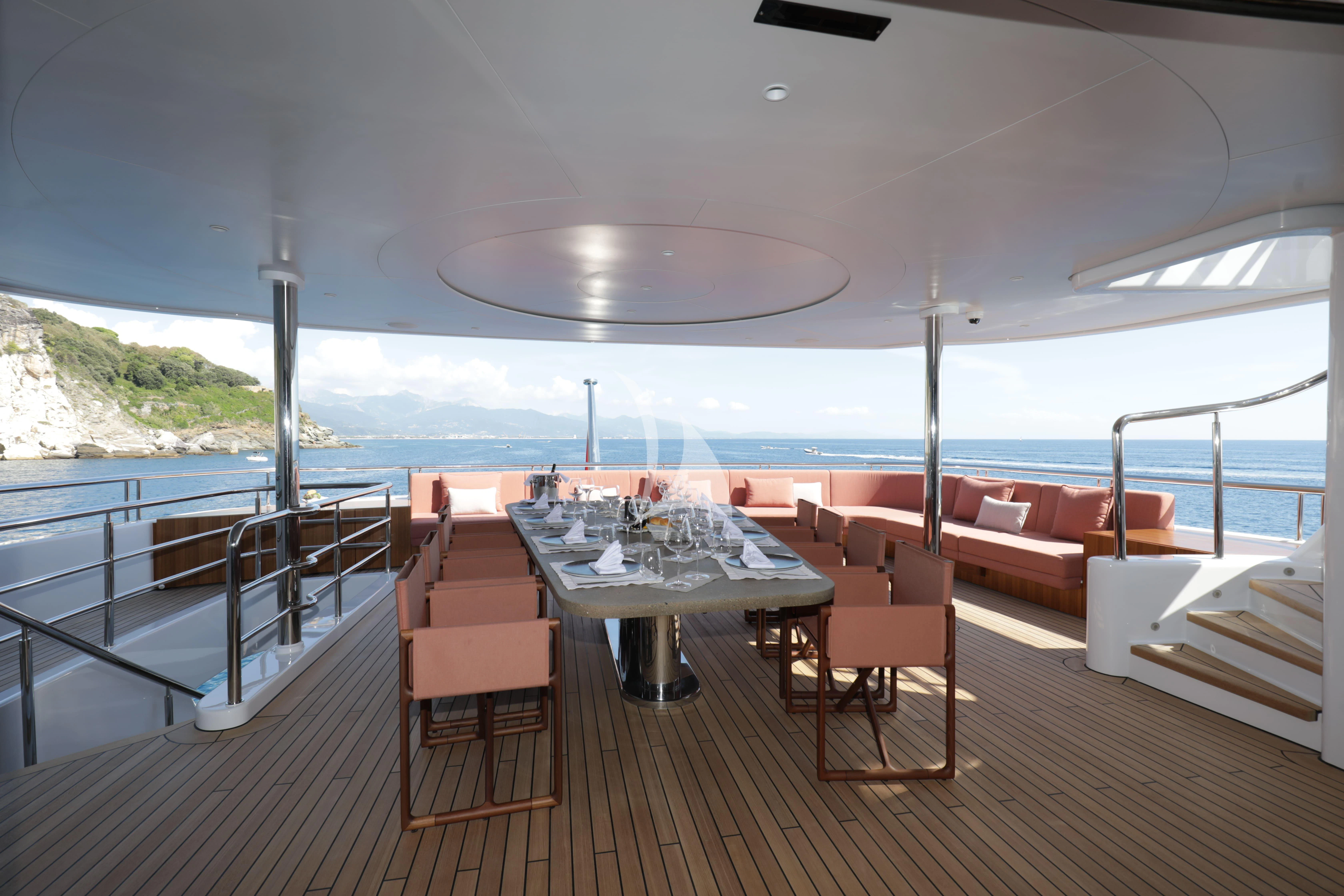 a room with a table and chairs aboard TIREA Yacht for Sale