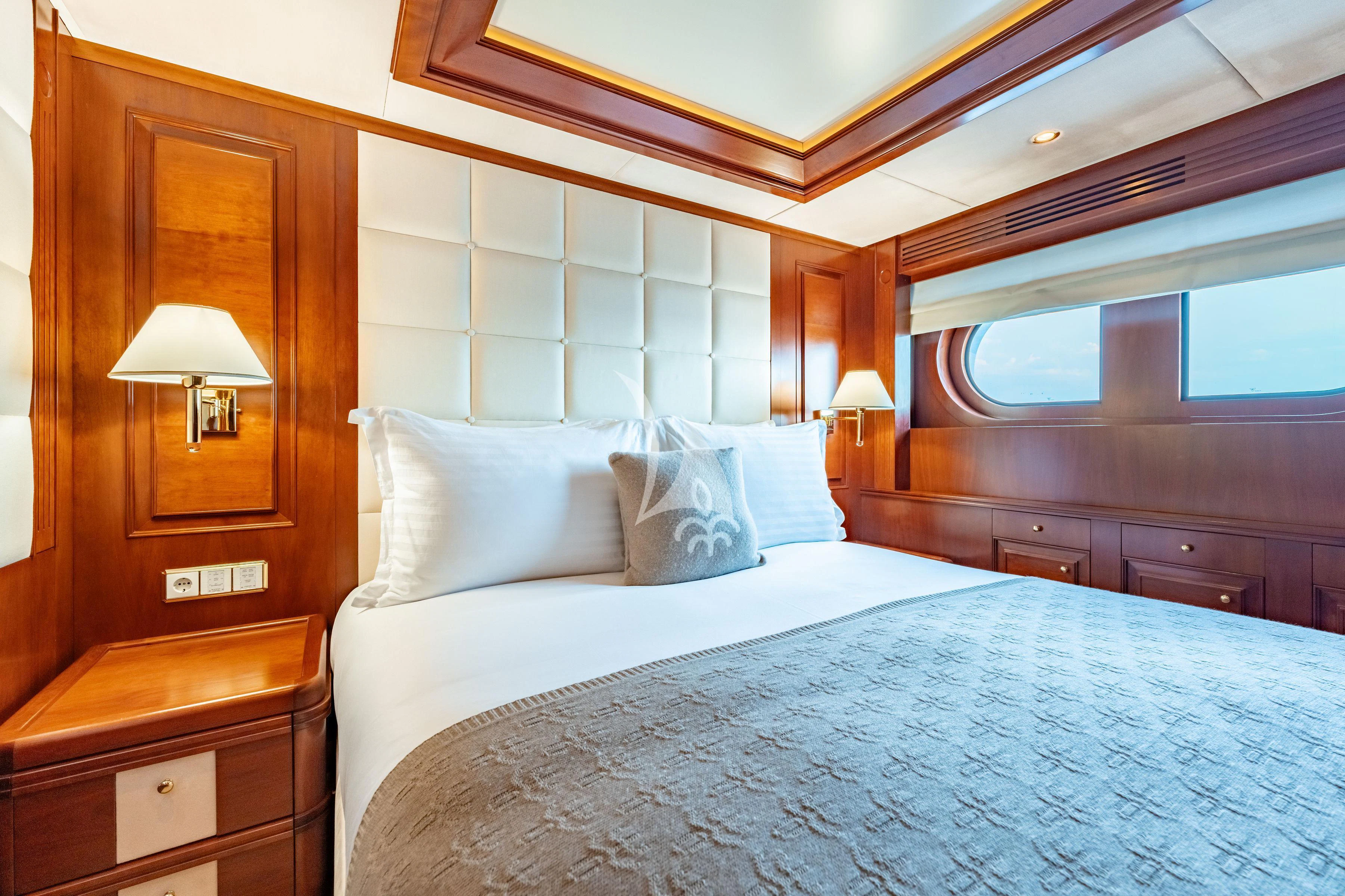 a bed with a white comforter aboard TIREA Yacht for Sale