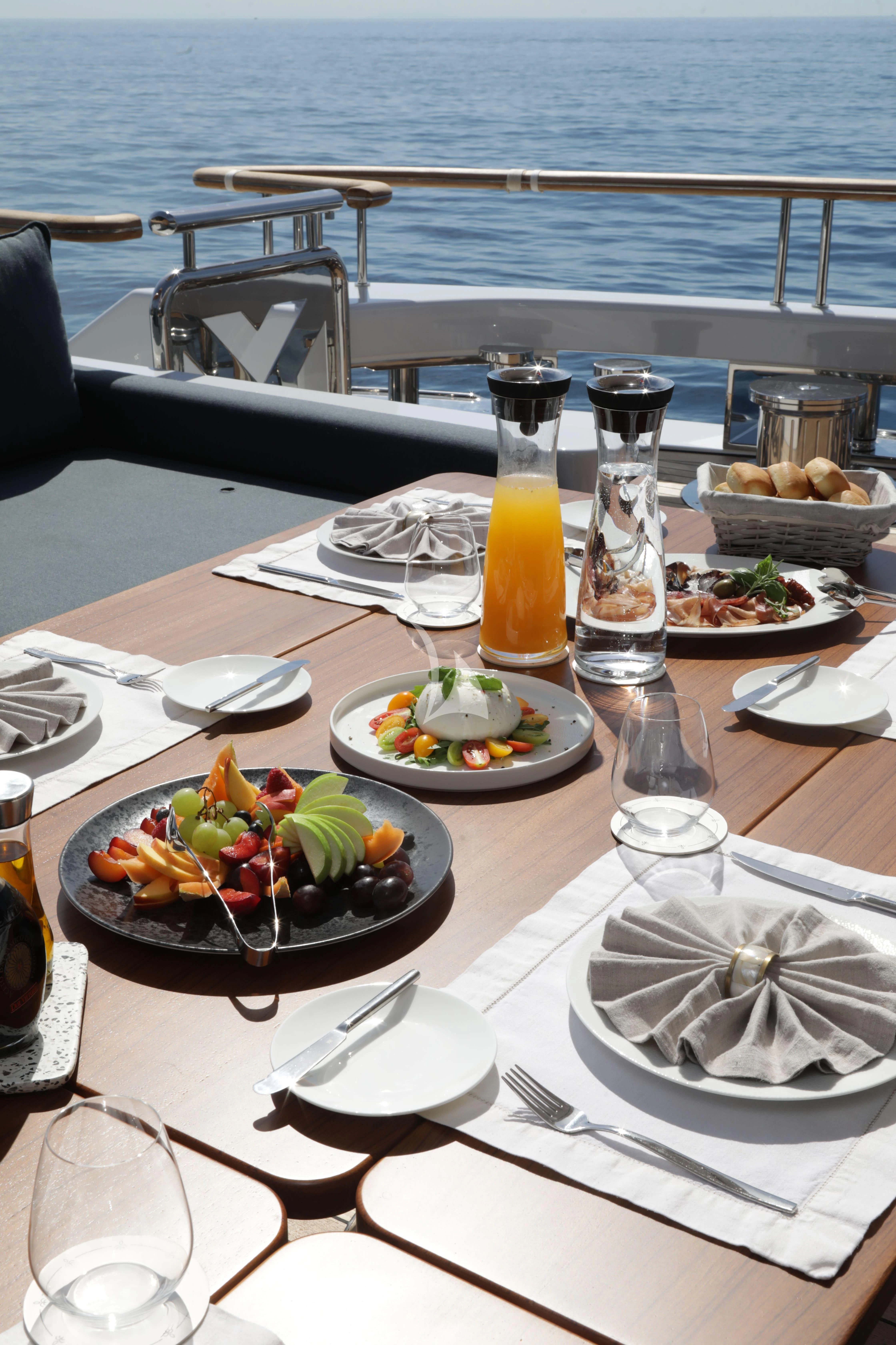a table with food and drinks on it aboard TIREA Yacht for Sale